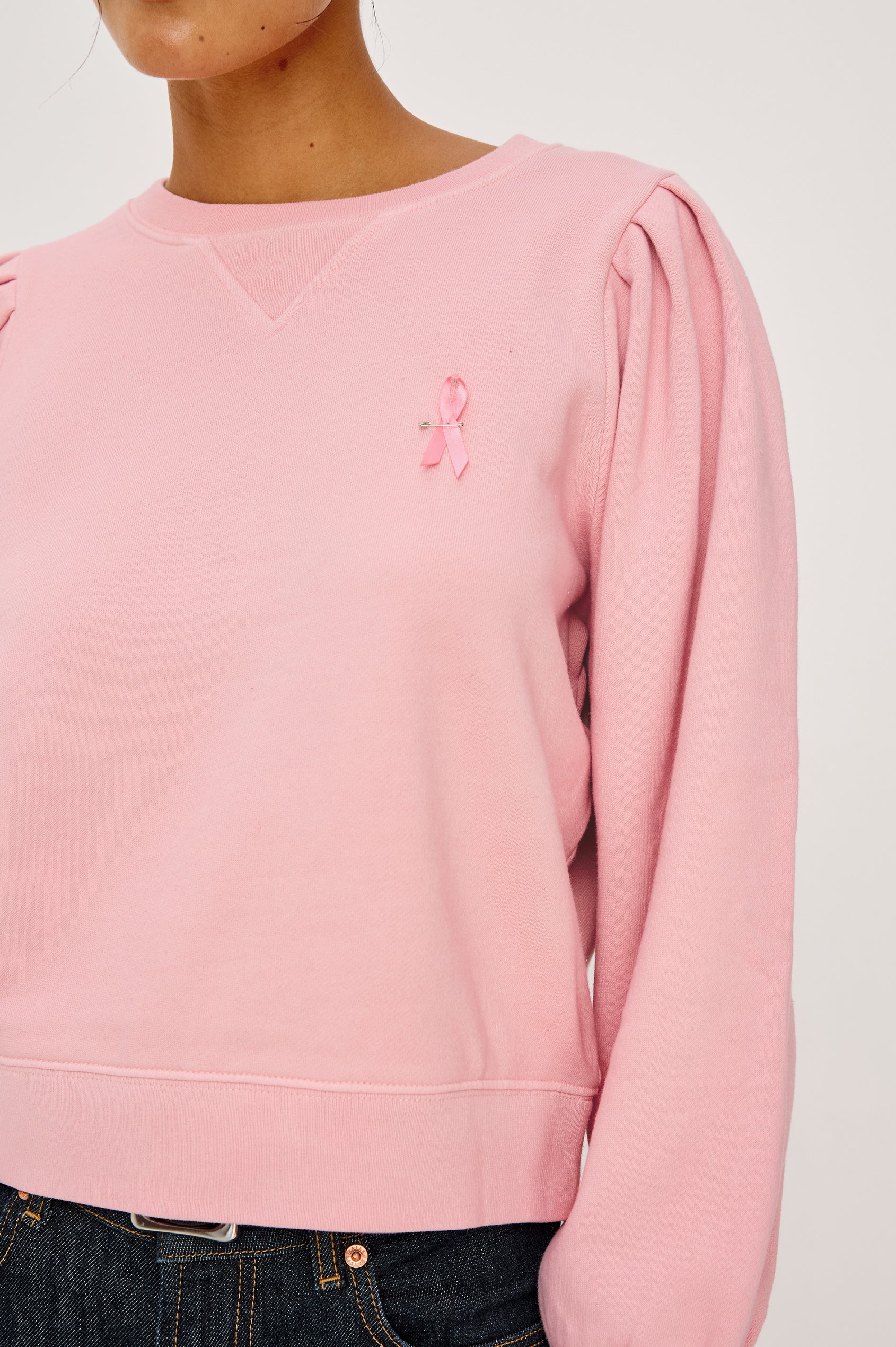 Tiffany Long-Sleeve Sweatshirt with a Crew Neck and Deep Pleated Sleeves in Faded Brave Pink Colorway for Breast Cancer Awareness - Close up View Featured on Model