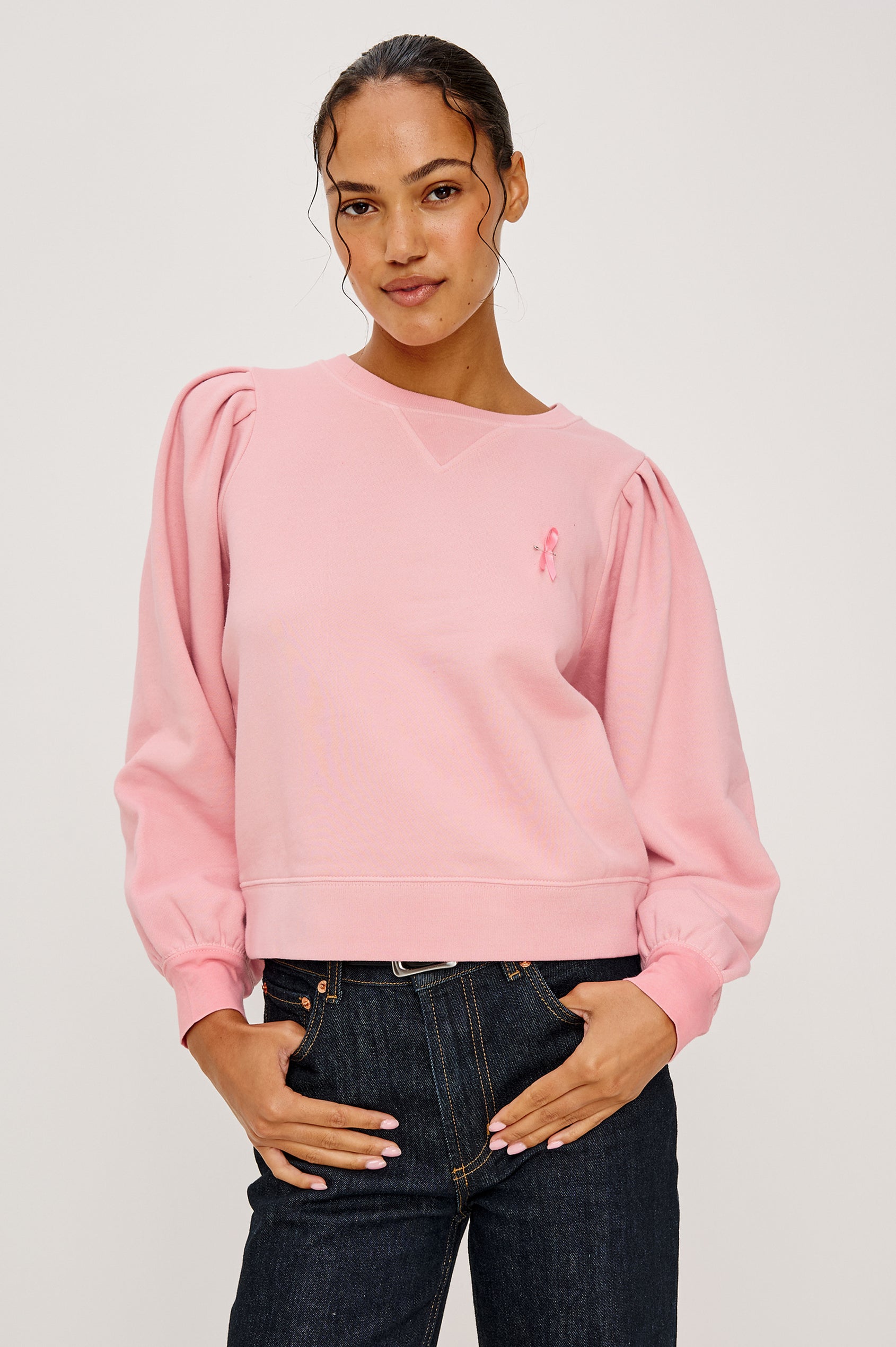 Tiffany Long-Sleeve Sweatshirt with a Crew Neck and Deep Pleated Sleeves in Faded Brave Pink Colorway for Breast Cancer Awareness - Front View Featured on Model