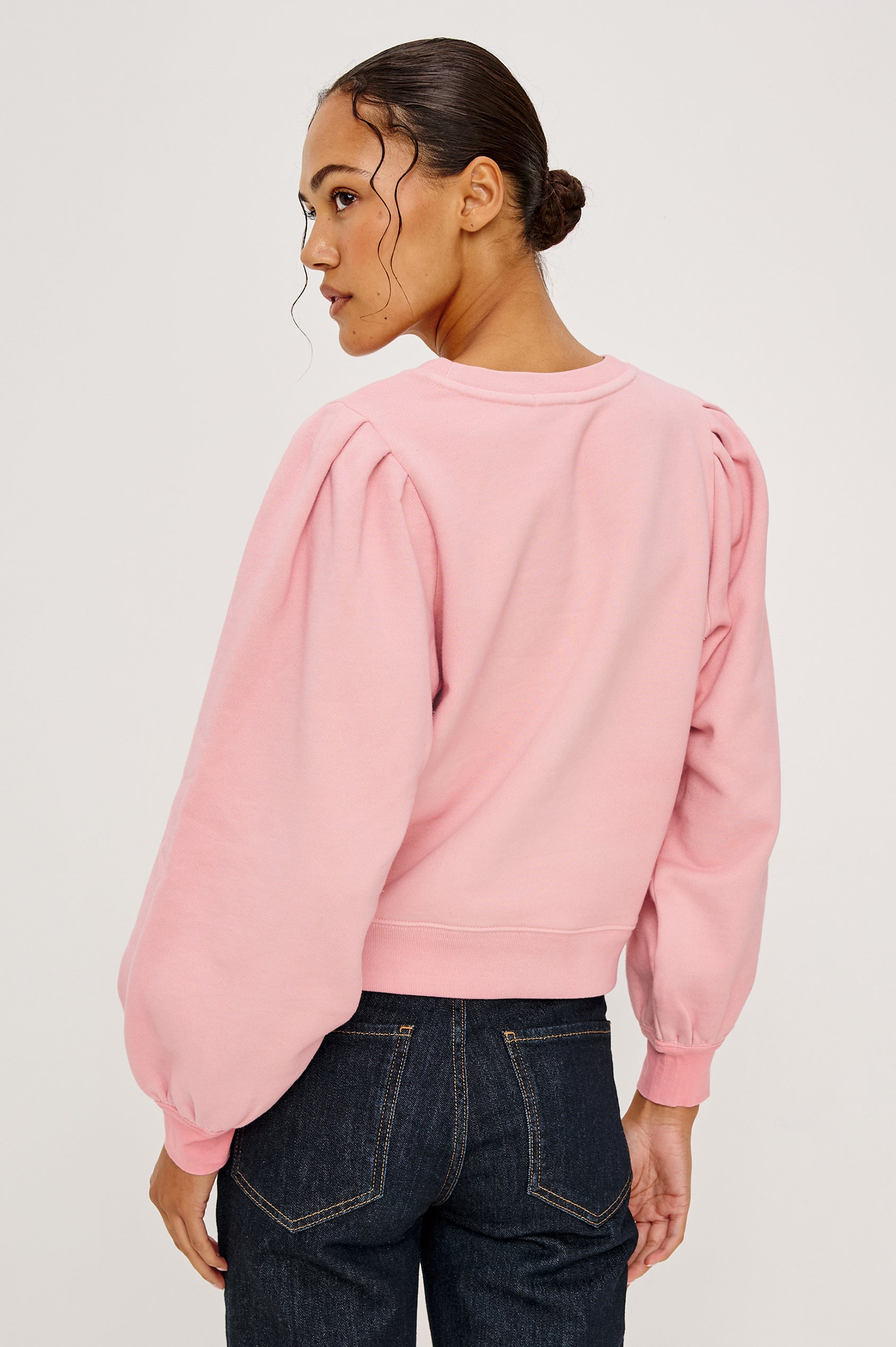 Tiffany Long-Sleeve Sweatshirt with a Crew Neck and Deep Pleated Sleeves in Faded Brave Pink Colorway for Breast Cancer Awareness - Back View Featured on Model