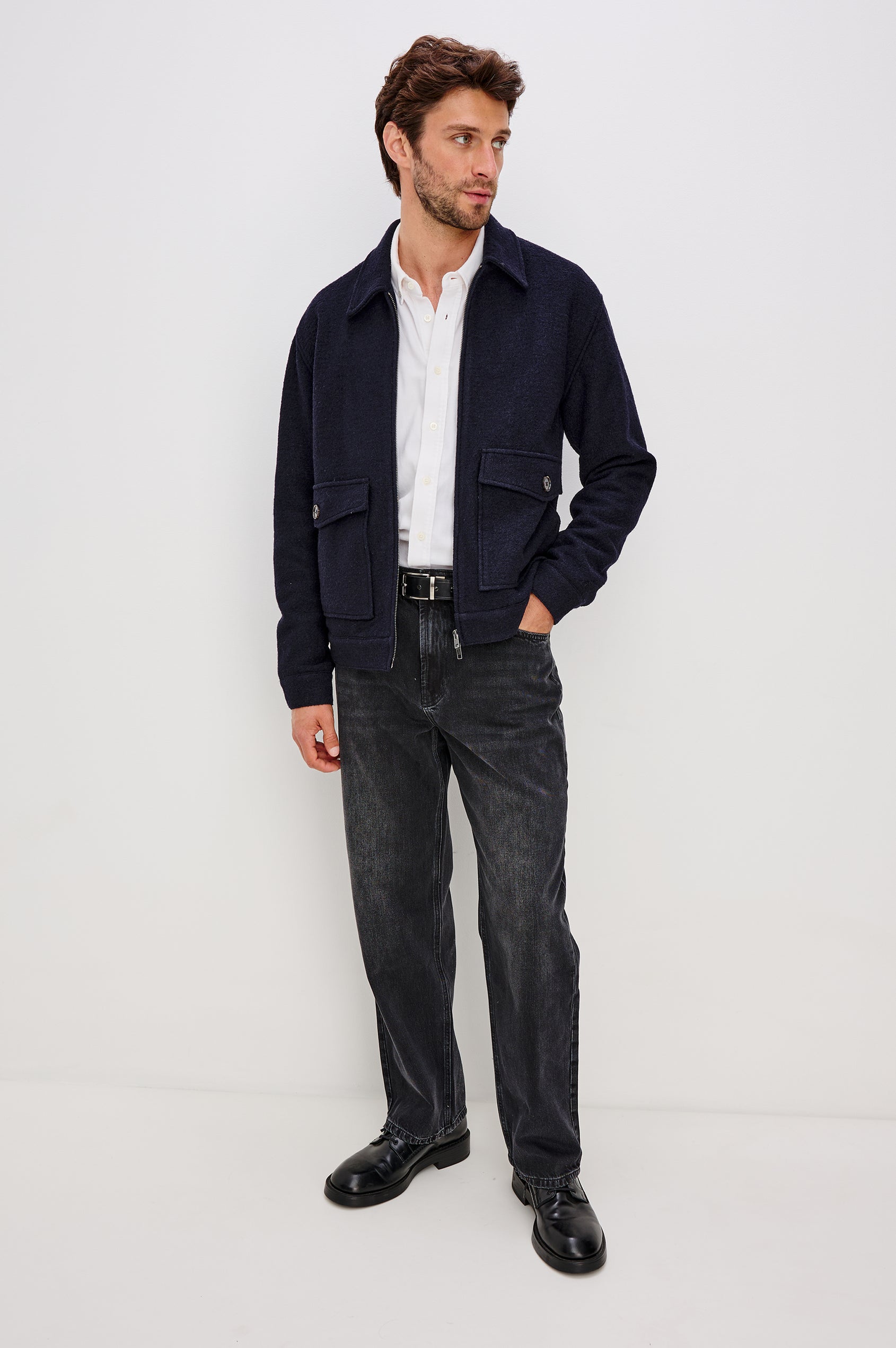 Tilman is a classic collar, front zip jacket, buttoned pockets with top and side entry in Navy Boucle colorway. Front full body view featured on model.