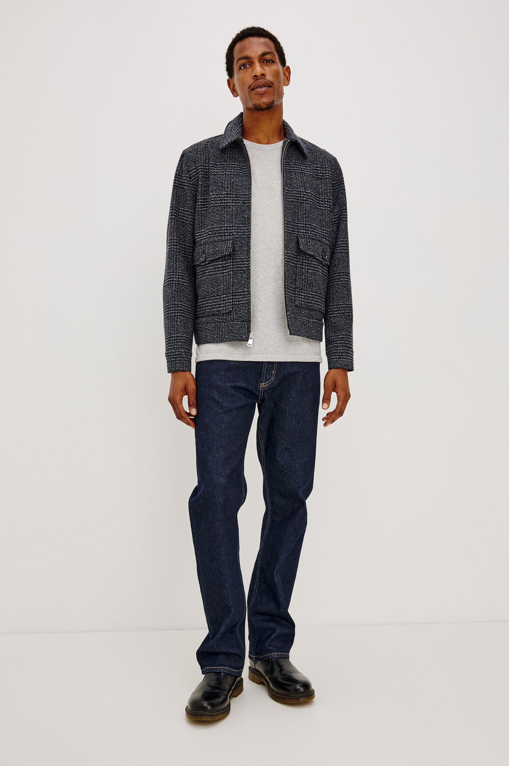 Tillman Jacket in Midweight Textured Wool Blend With Full Custom Lining, Front Zip, Spread Collar, Front Flap Side Entry Pockets, Relaxed FIt, and Long Sleeves in Navy Static Plaid Colorway - Full Body Front View Featured on Model.