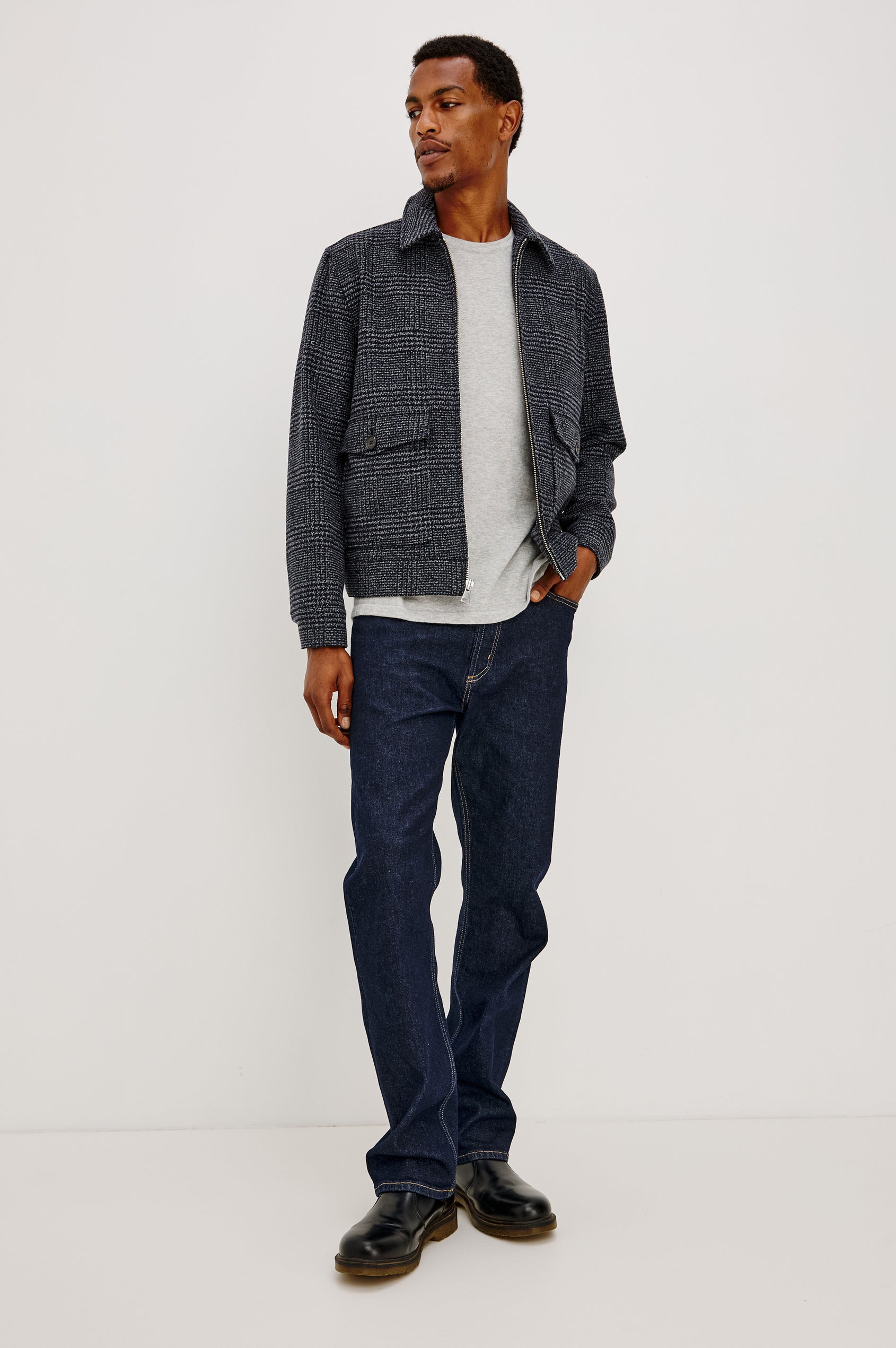 Tillman Jacket in Midweight Textured Wool Blend With Full Custom Lining, Front Zip, Spread Collar, Front Flap Side Entry Pockets, Relaxed FIt, and Long Sleeves in Navy Static Plaid Colorway - Full Body Front View Featured on Model.