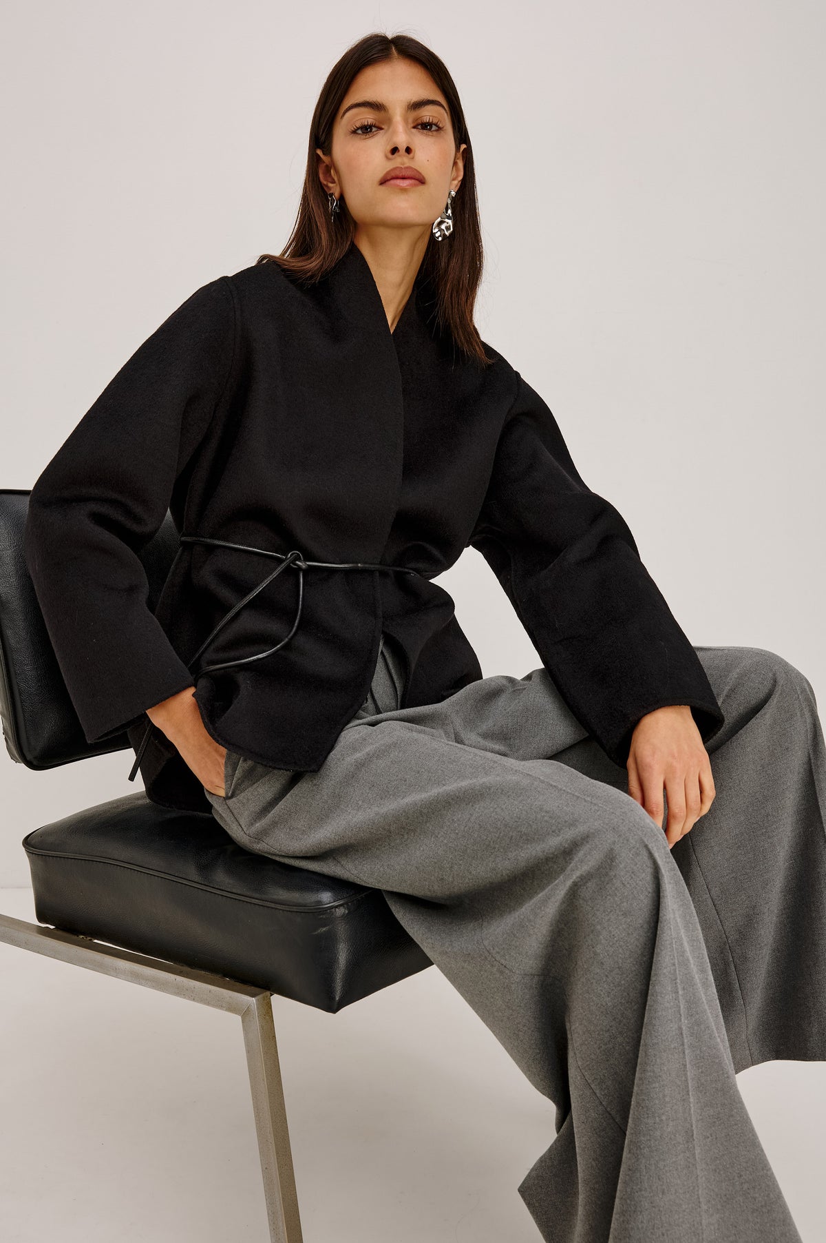 Tokyo Jacket in Wool Blend With Collarless Neckline, Leather Belt Ties, Long Sleeves, and Relaxed, Boxy Fit in Black Colorway - Front View Featured on Model.