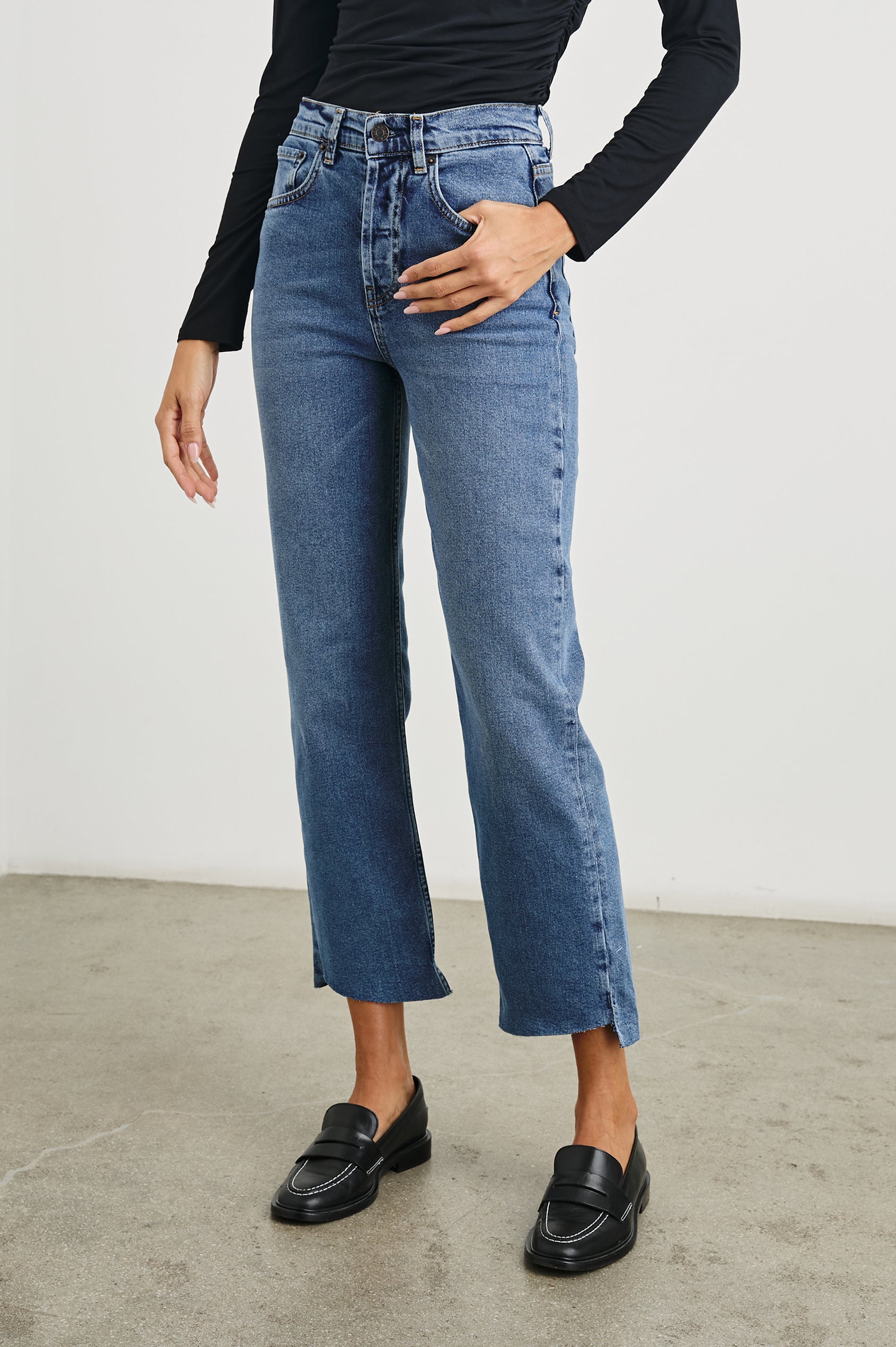 Topanga Crop Straight Jeans with an Asymmetrical Crop, Belt Loops, Two Front Pockets plus a Coin Pocket and Two Back Patch Pockets in Pure Indigo Colorway - Front View Featured on Model