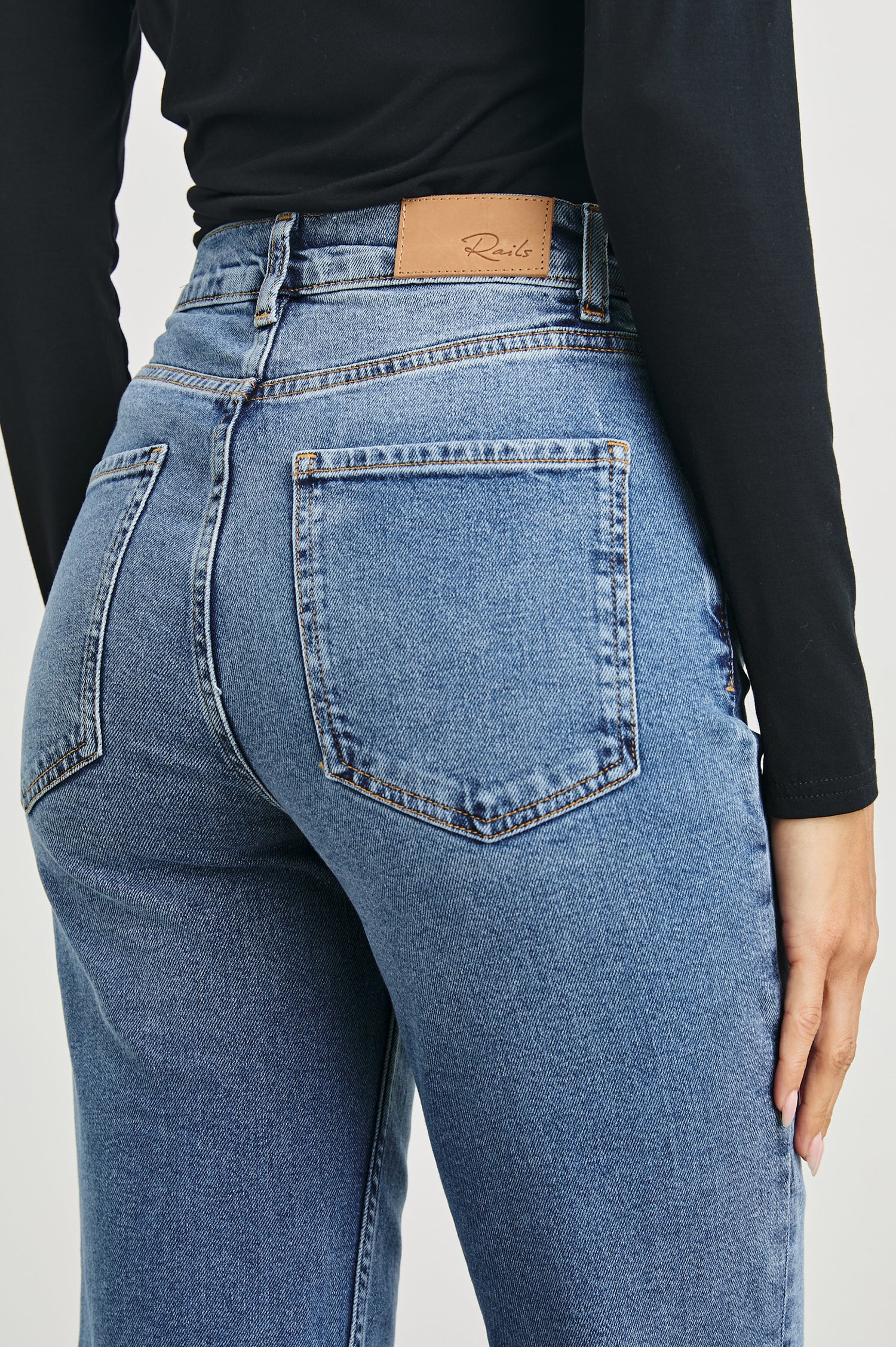Topanga Crop Straight Jeans with an Asymmetrical Crop, Belt Loops, Two Front Pockets plus a Coin Pocket and Two Back Patch Pockets in Pure Indigo Colorway - Back View Featured on Model
