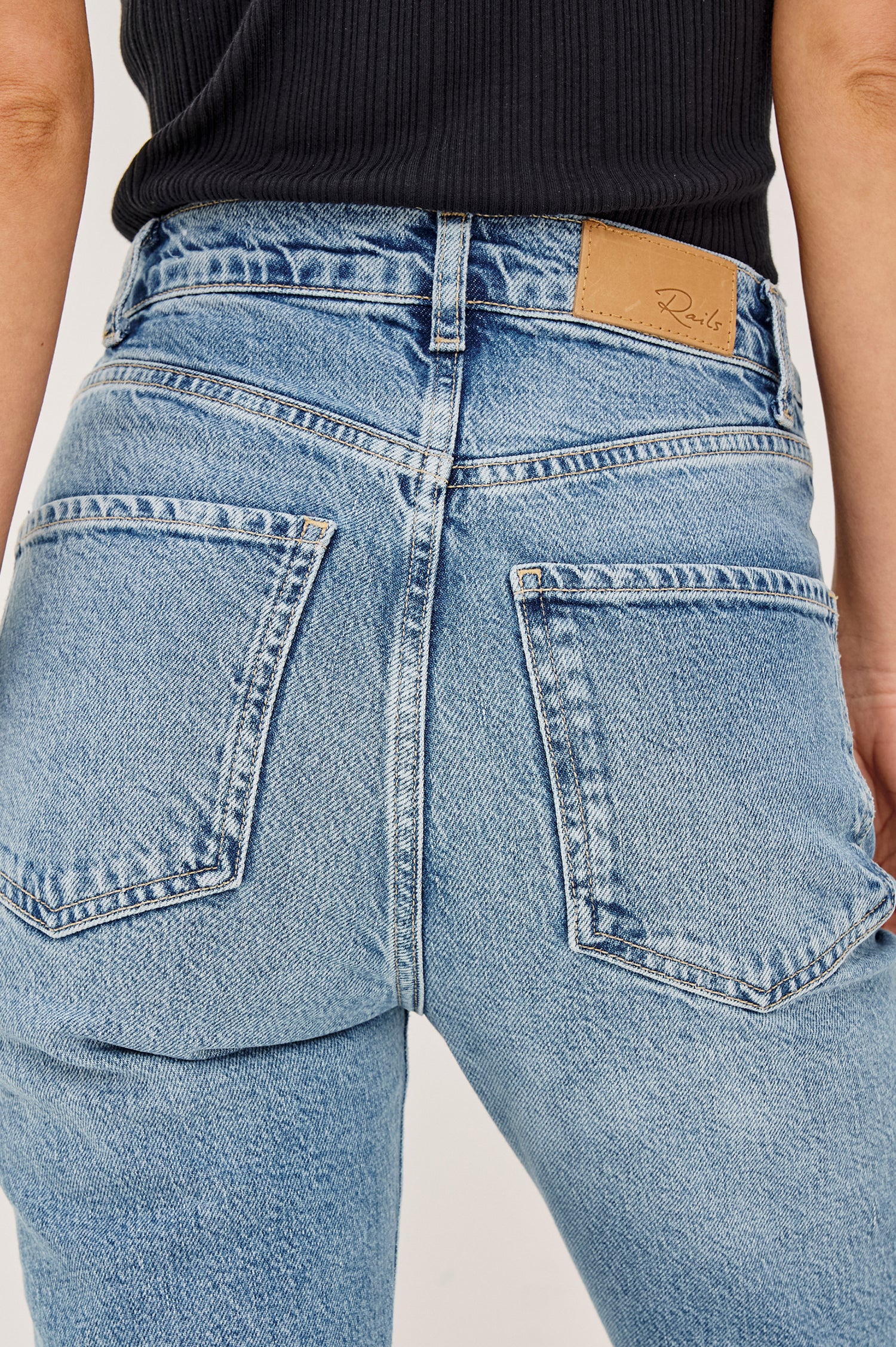 Topanga Petite High-Rise Wide Straight Leg Jean in With 5-Pockets and a Front Zip-Fly in Old Indigo Colorway - Close up View Featured on Model