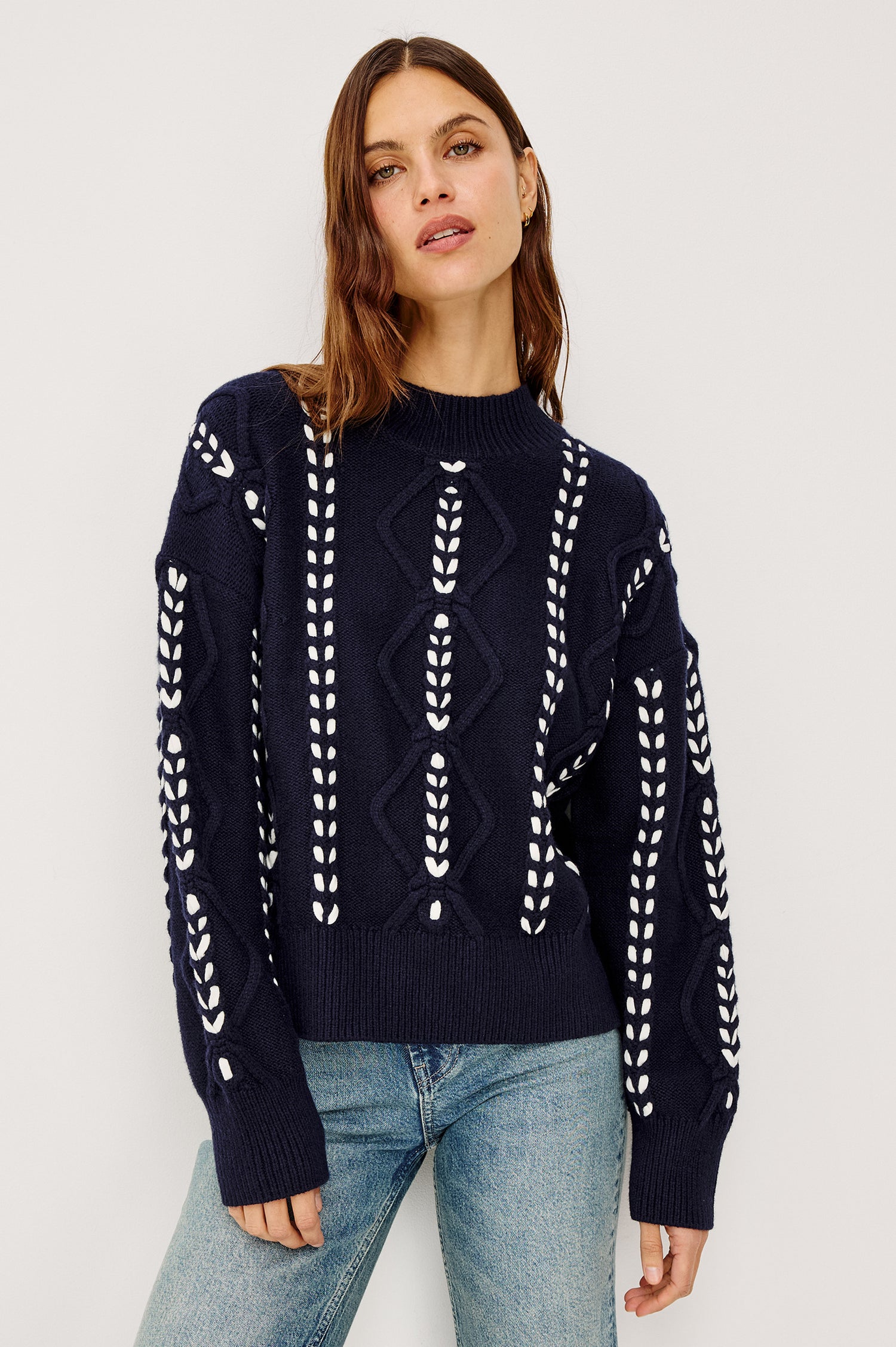 Tori Sweater in Wool Blend Cable Knit With Contrast Ribbon Stitching, a Ribbed Mock Neckline, Long Sleeves, and a Boxy Fit in Midnight Colorway - Upper Body Front View Featured on Model