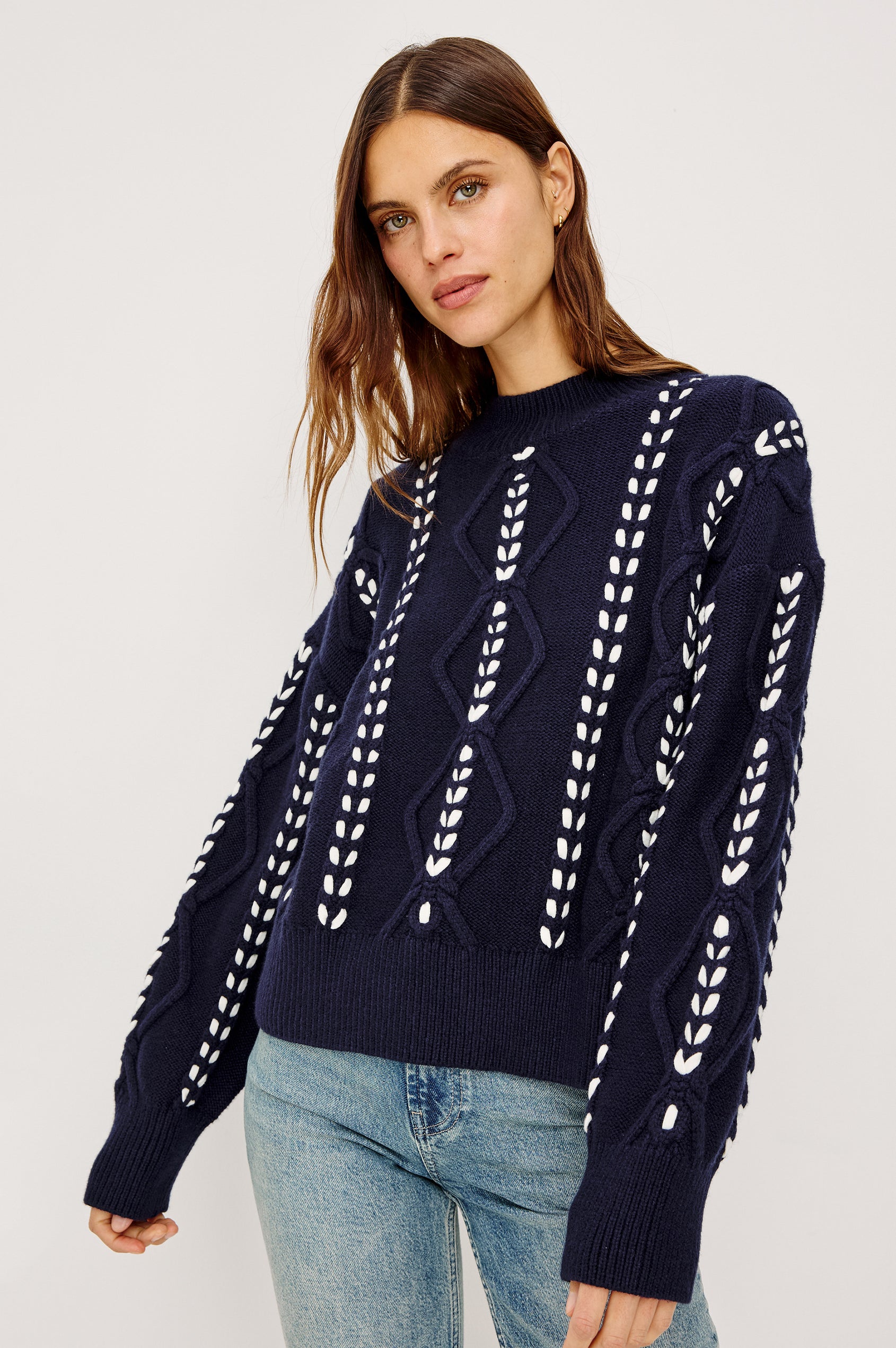 Tori Sweater in Wool Blend Cable Knit With Contrast Ribbon Stitching, a Ribbed Mock Neckline, Long Sleeves, and a Boxy Fit in Midnight Colorway - Upper Body Front View Featured on Model