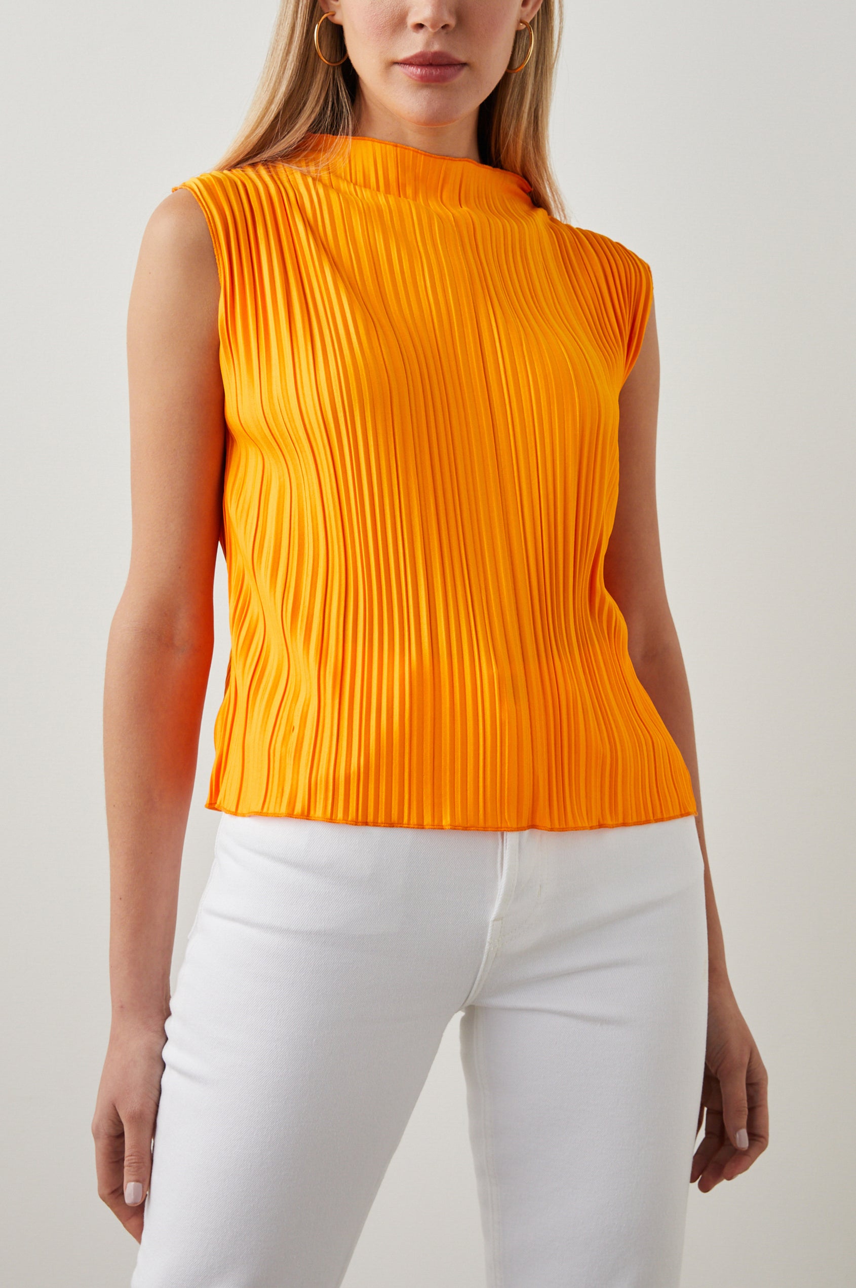 Trea Sleeveless Top with a Mock Neck and Pleated Texture in Marigold Colorway - Front View Featured on Model