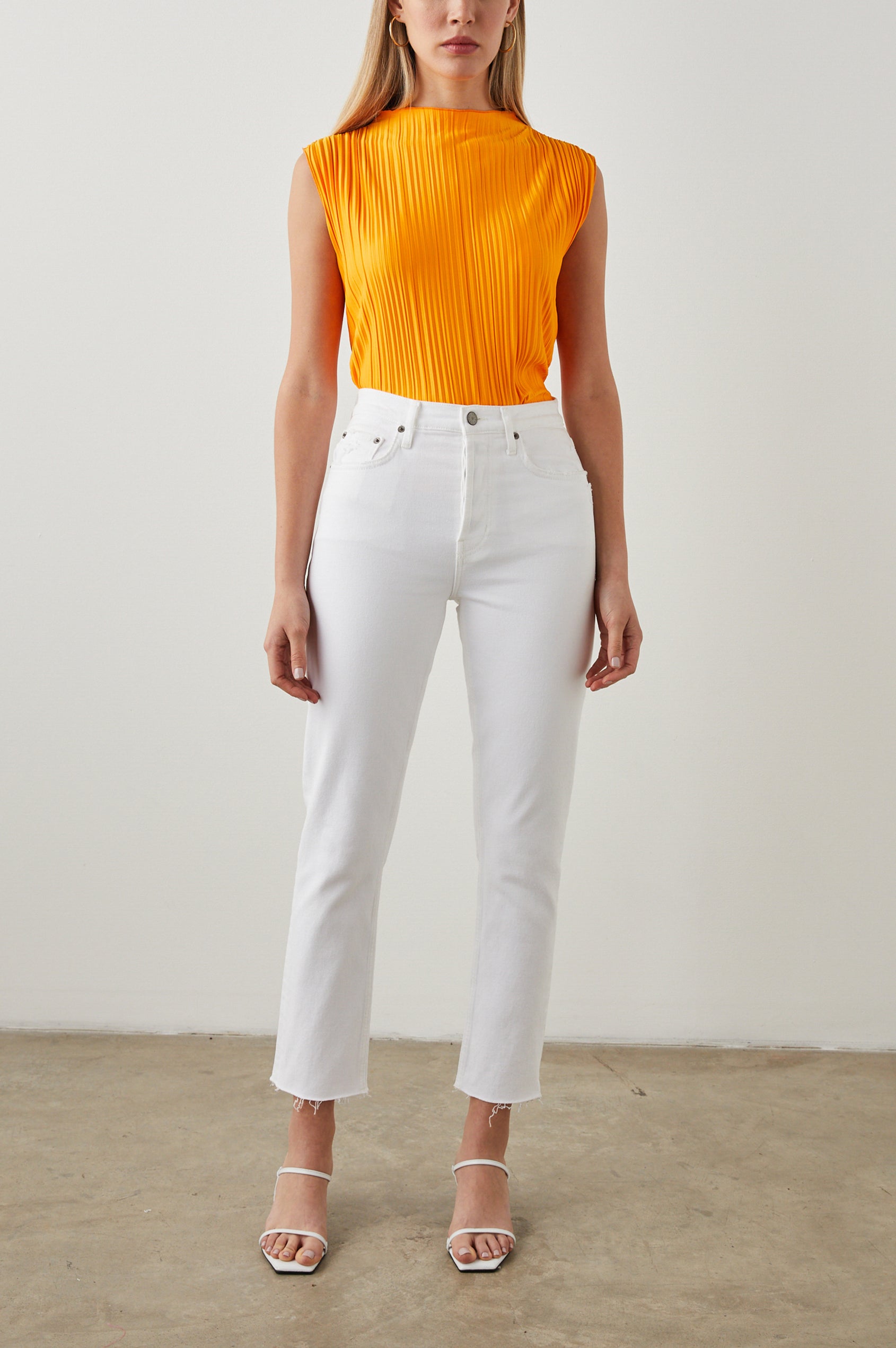 Trea Sleeveless Top with a Mock Neck and Pleated Texture in Marigold Colorway - Front Full Body View Featured on Model