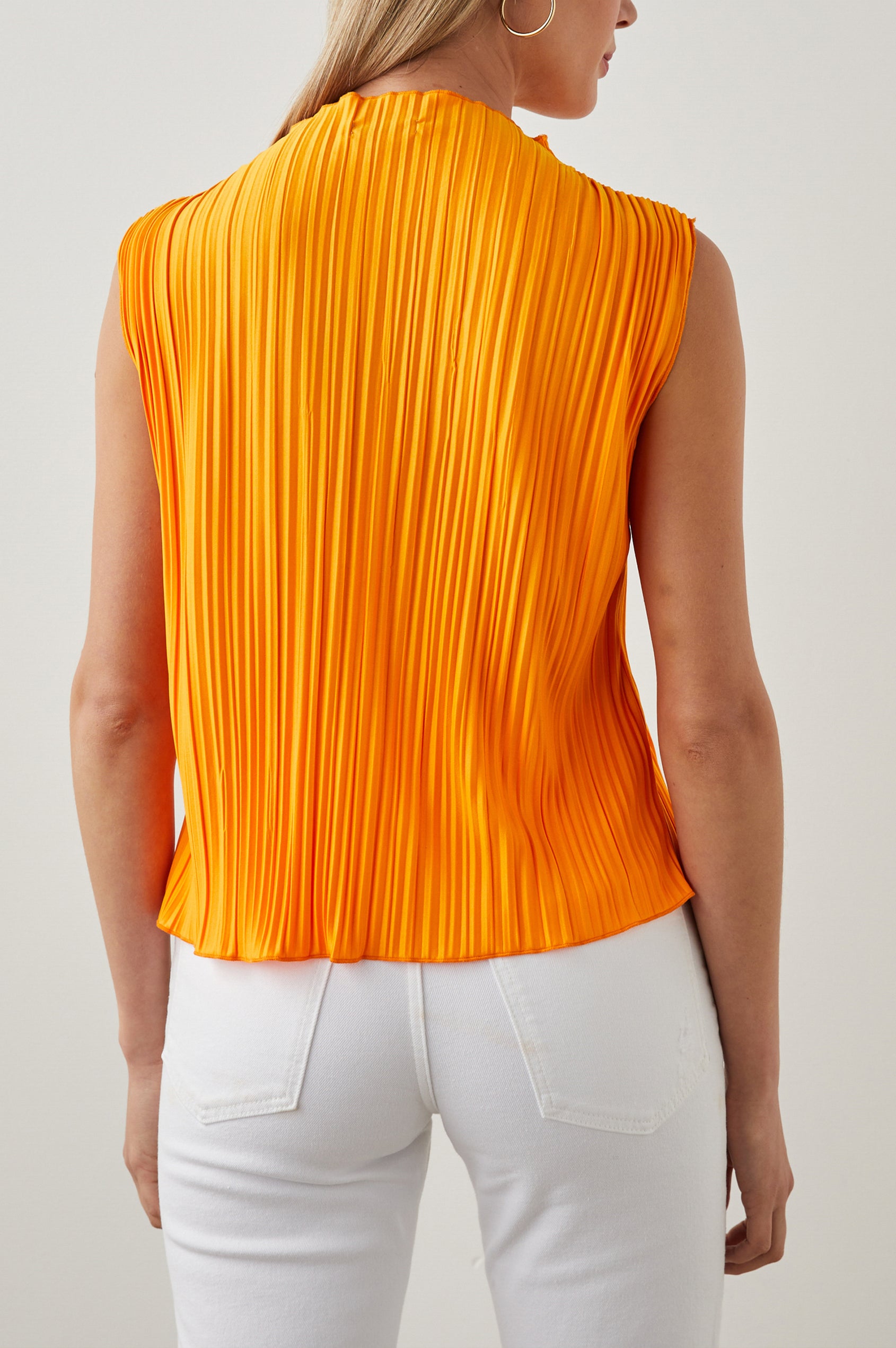 Trea Sleeveless Top with a Mock Neck and Pleated Texture in Marigold Colorway - Back View Featured on Model
