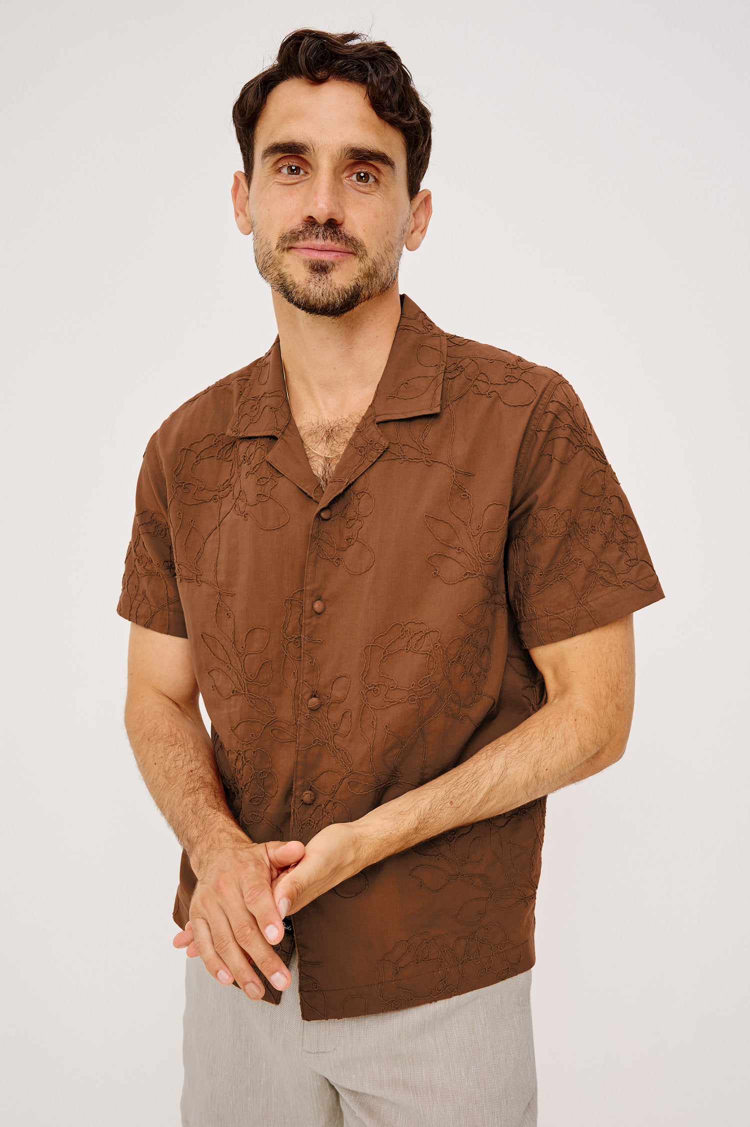 Tyler Shirt in Stretch Cotton With Floral Jute Embroidery, Front Buttons, Notched Collar, Short Sleeves, and Classic Fit in Rope Rust Colorway - Upper Body Front View Featured on Model