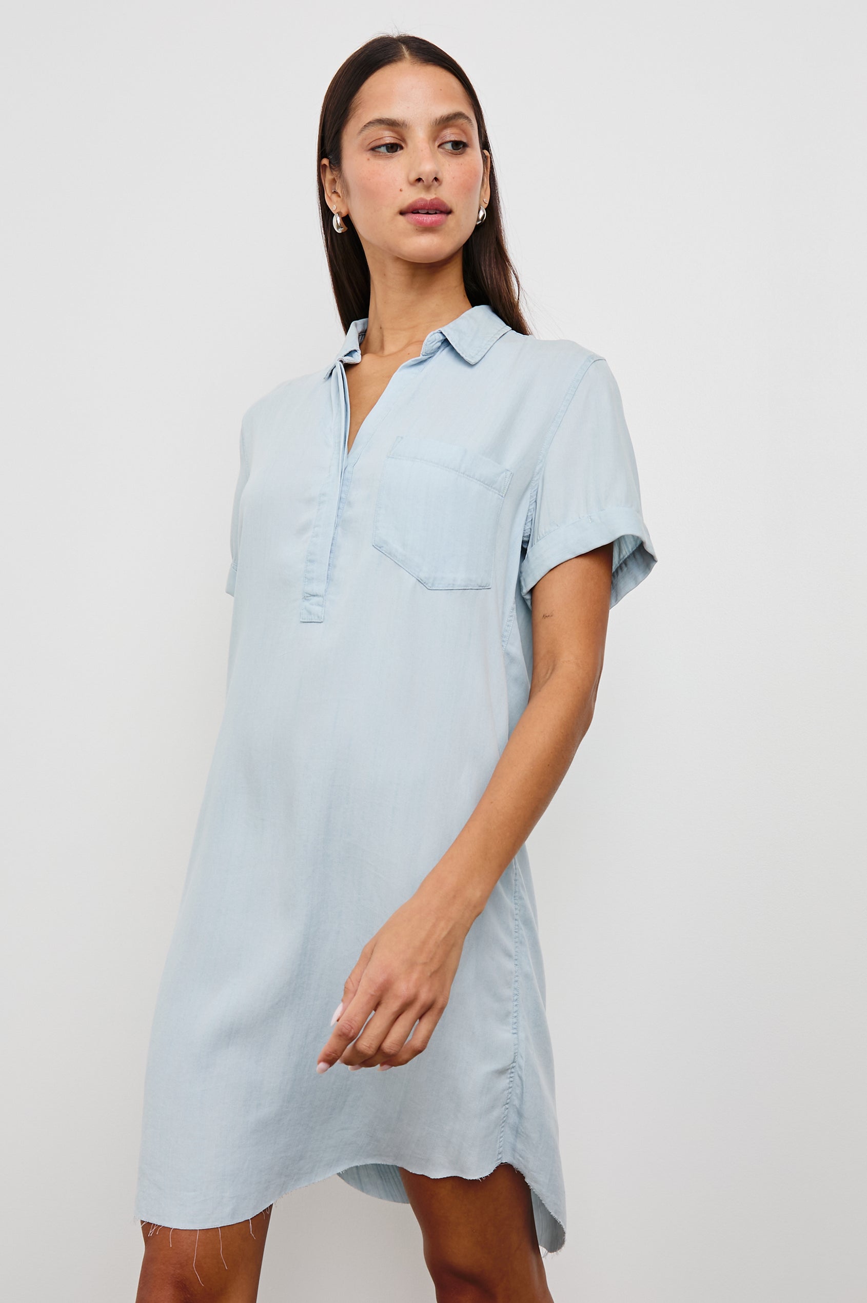 Valerie Short-Sleeve Denim Mini Dress with Rolled Cuffs, a Collar, a Half Sealed Placket, a Chest Pocket and a Raw Hem in Light Vintage Colorway - Front View Featured on Model 