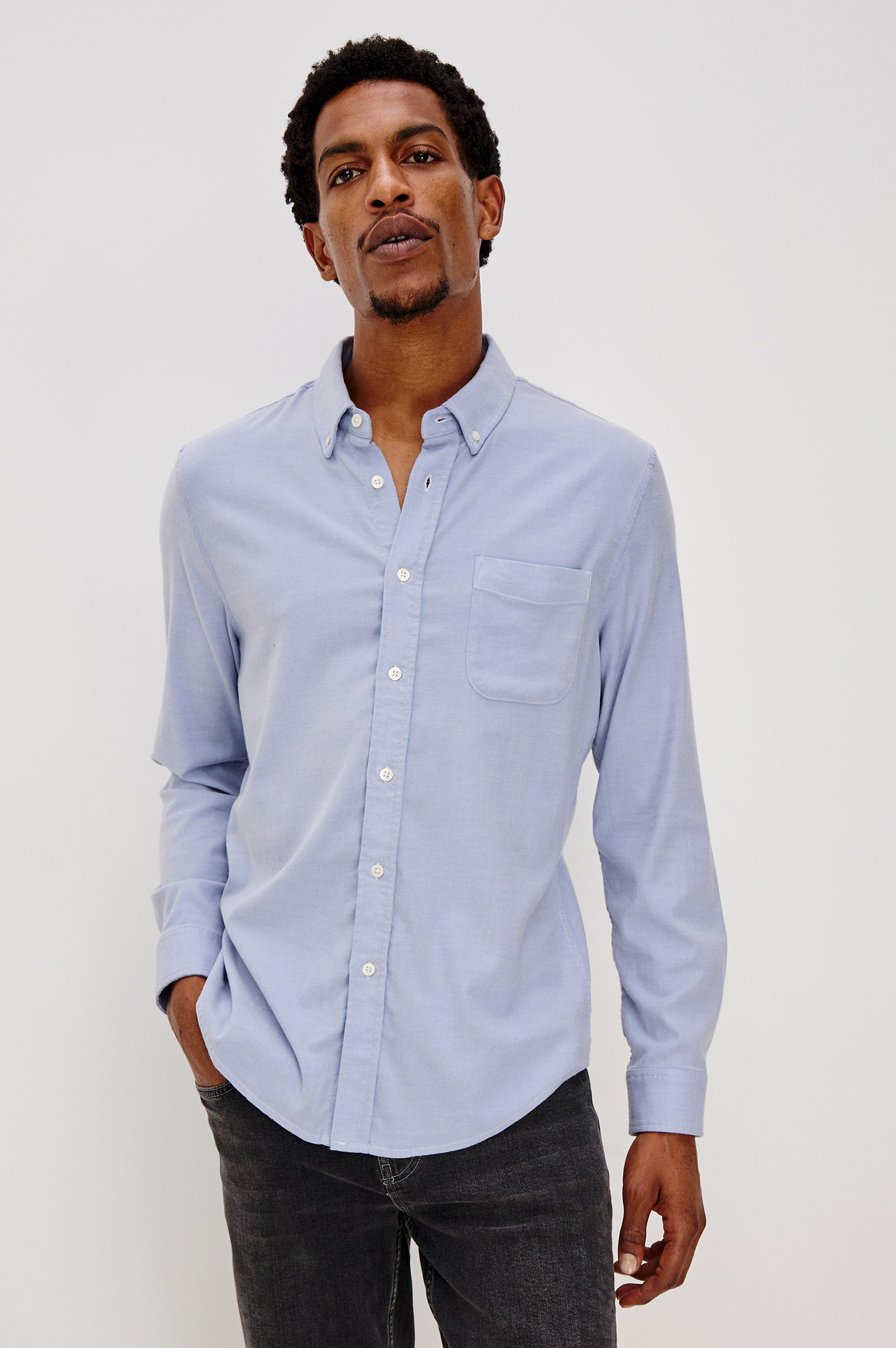 Vance button front collared shirt with long sleeves, collard stand buttons and a single chest pocket in Blue Oxford colorway. Front view shown on model.