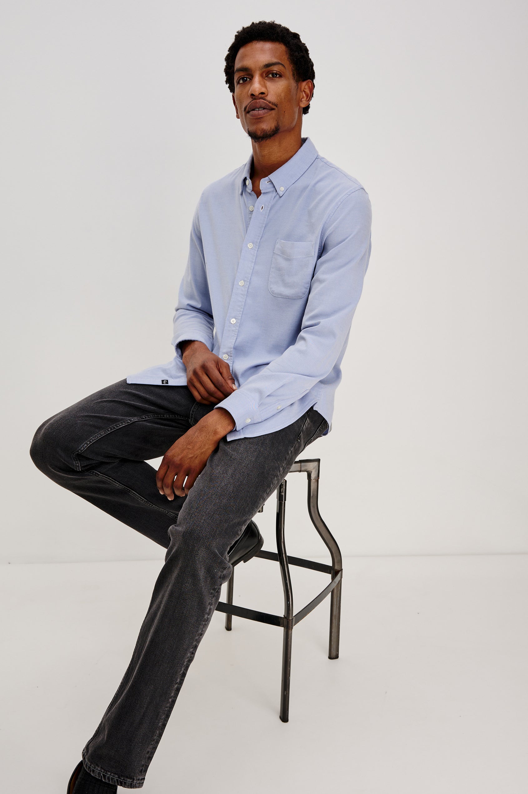 Vance button front collared shirt with long sleeves, collard stand buttons and a single chest pocket in Blue Oxford colorway. Front view shown on model.