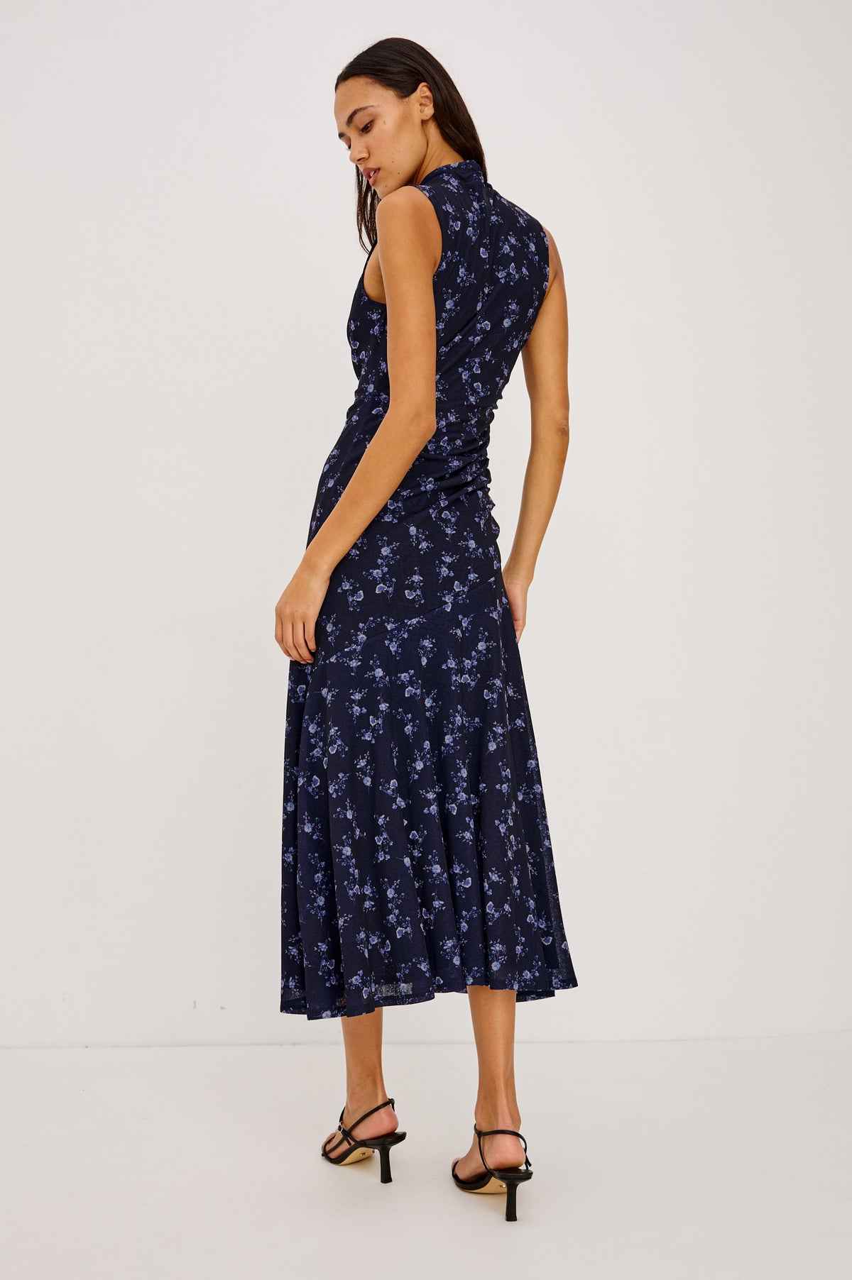 Vanya Maxi Dress in Stretch Mesh With Fitted Wrap-Style Bodice, Side Ruching, and Angled Tier Seam in Navy Romantic Floral Colorway - Full Body Back View Featured on Model