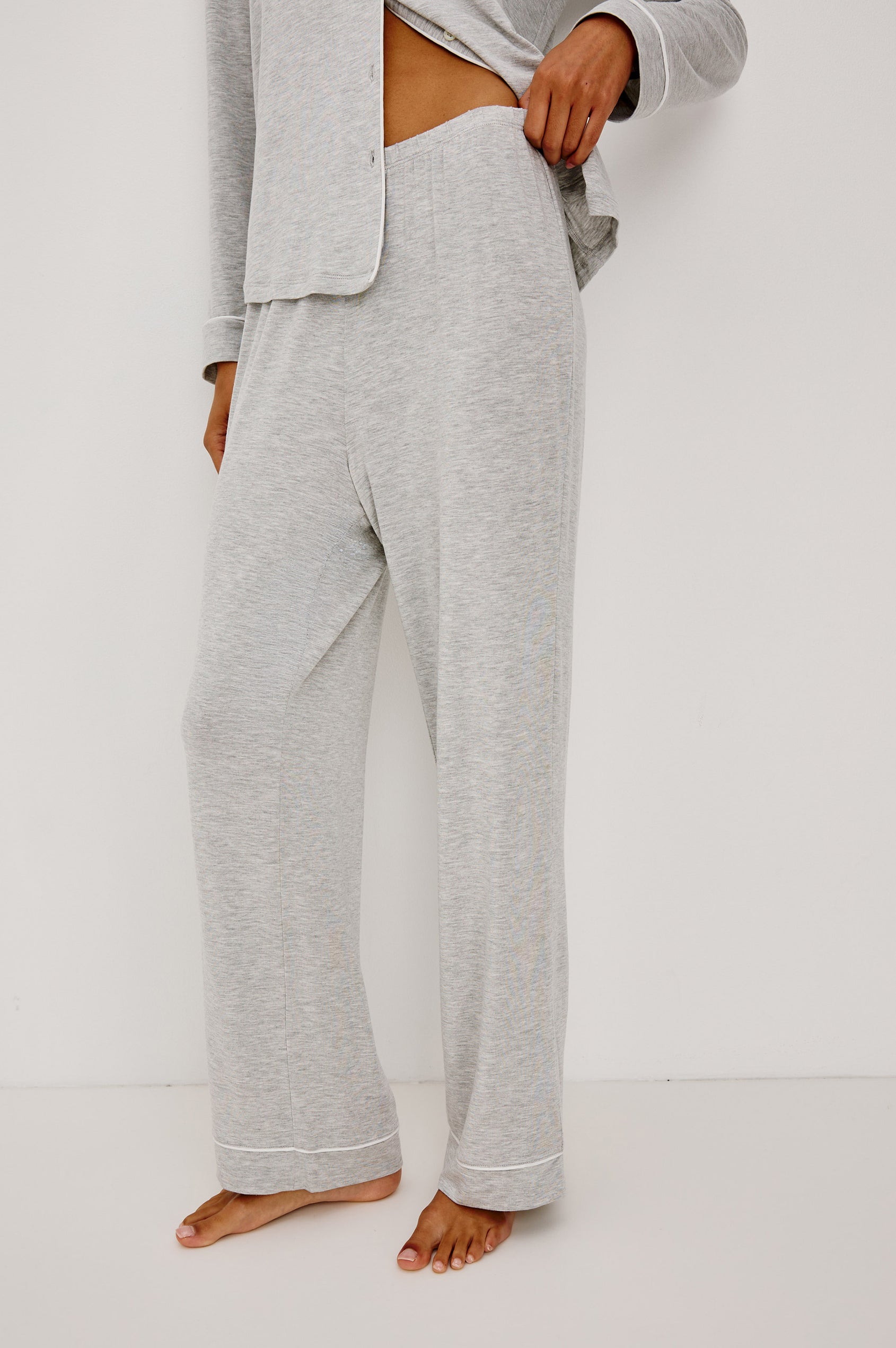 Varra Pajama Set in Soft Jersey With Contrast Piping, Relaxed Fit, Long Sleeve Collared Button-Up Shirt, and Straight-Leg Pants in Heather Grey Colorway - Lower Body Side View Featured on Model