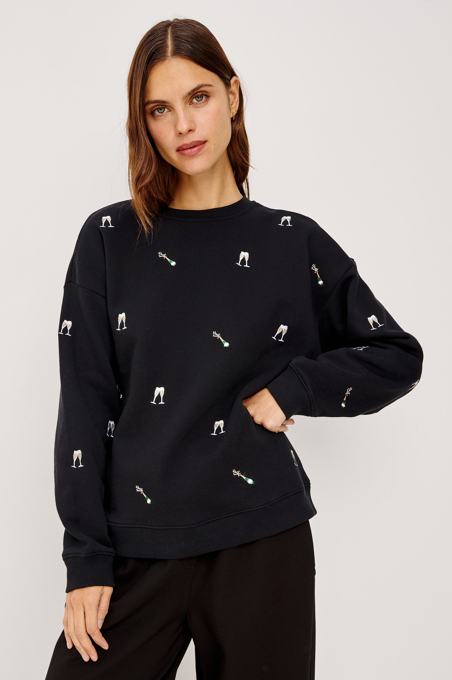 Ramona Crewneck Sweatshirt in Cotton Fleece With Embroidered Champagne Glasses, Dropped Shoulders, Long Sleeves, and Ribbed Trim in Black Champagne Embroidery Colorway - Upper Body Front View Featured on Model