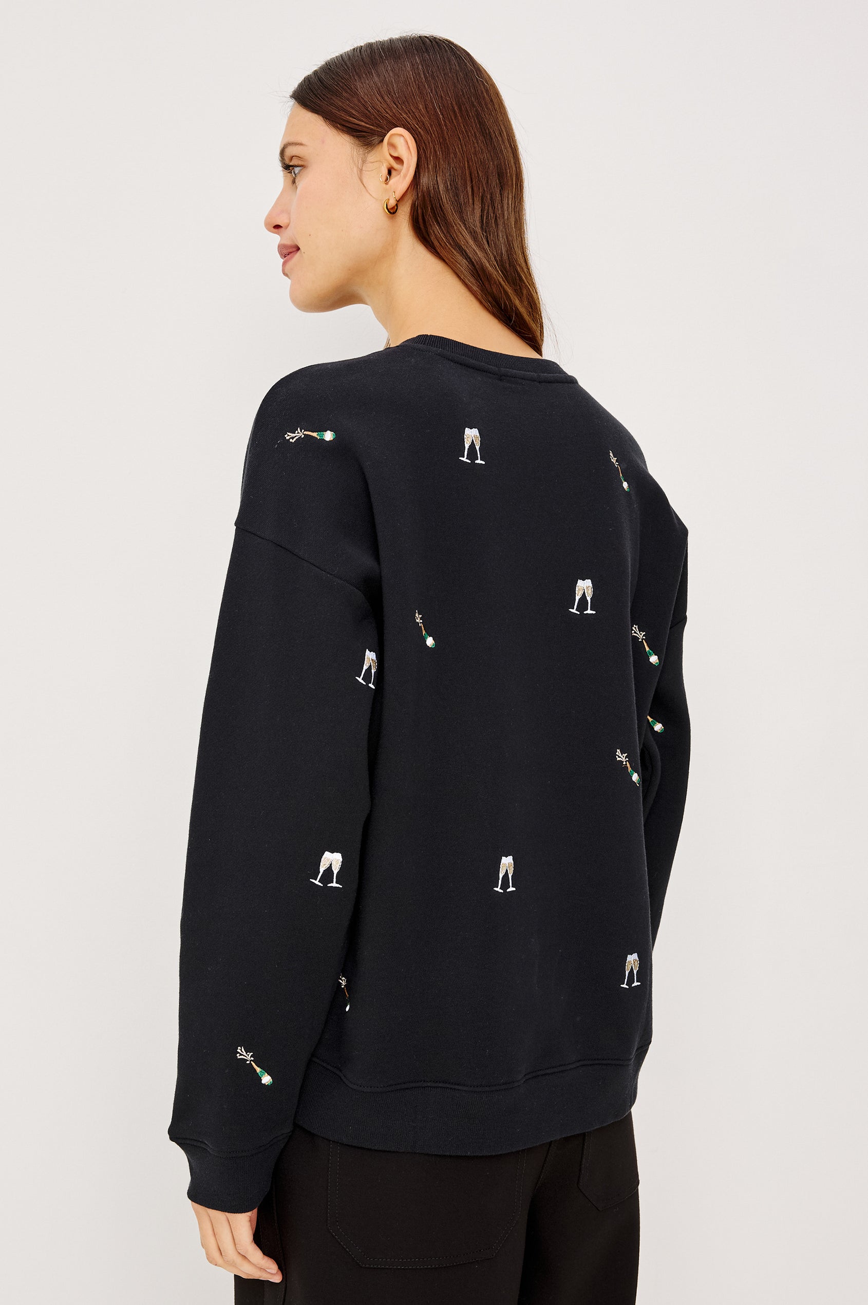 Ramona Crewneck Sweatshirt in Cotton Fleece With Embroidered Champagne Glasses, Dropped Shoulders, Long Sleeves, and Ribbed Trim in Black Champagne Embroidery Colorway - Upper Body Back View Featured on Model