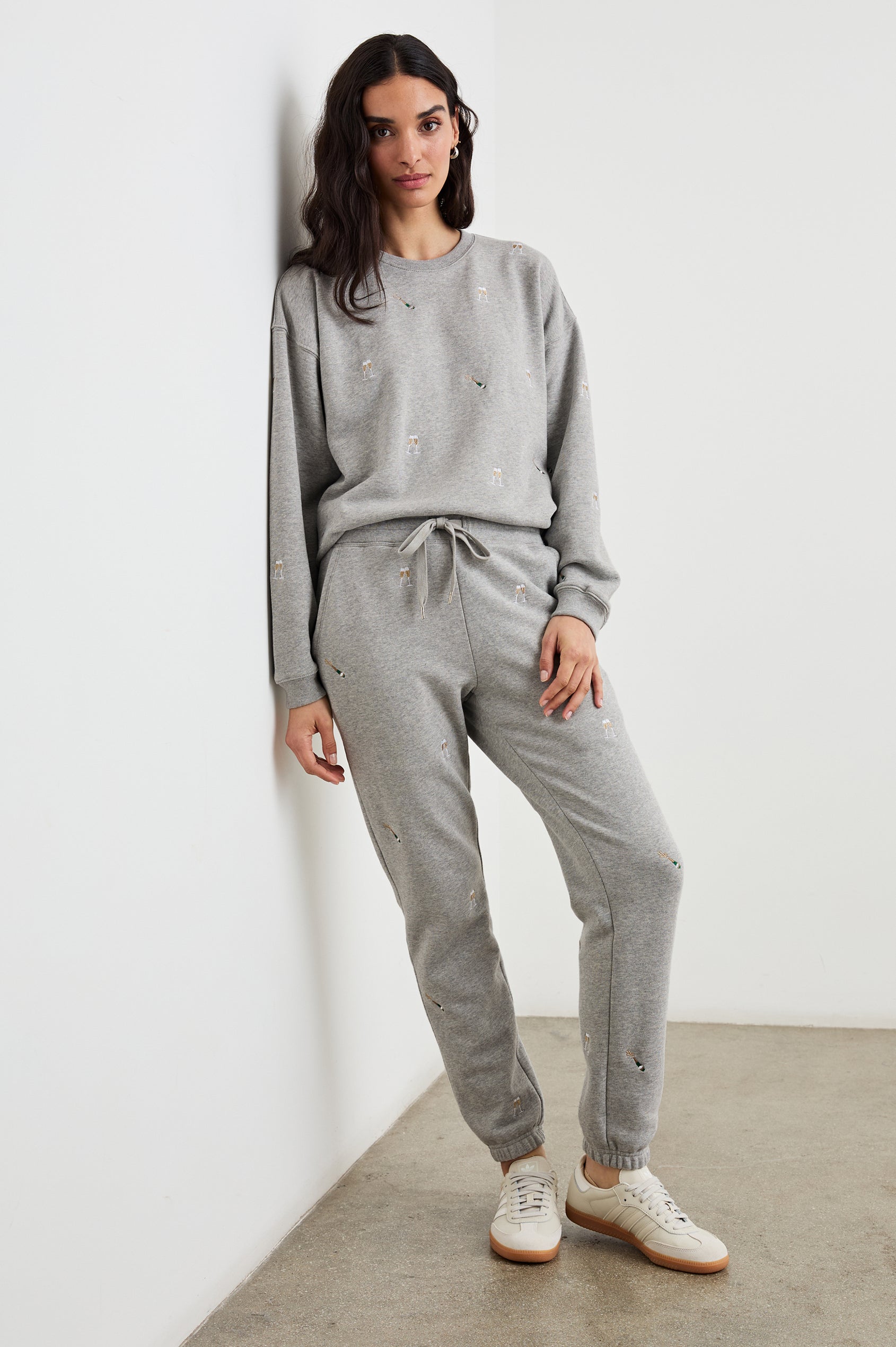 The Varsity Sweatshirt with a Crew Neck and embroidered Champagne Glasses in Champagne Embroidery Colorway, on light grey - Front Full Body View Featured on Model 
