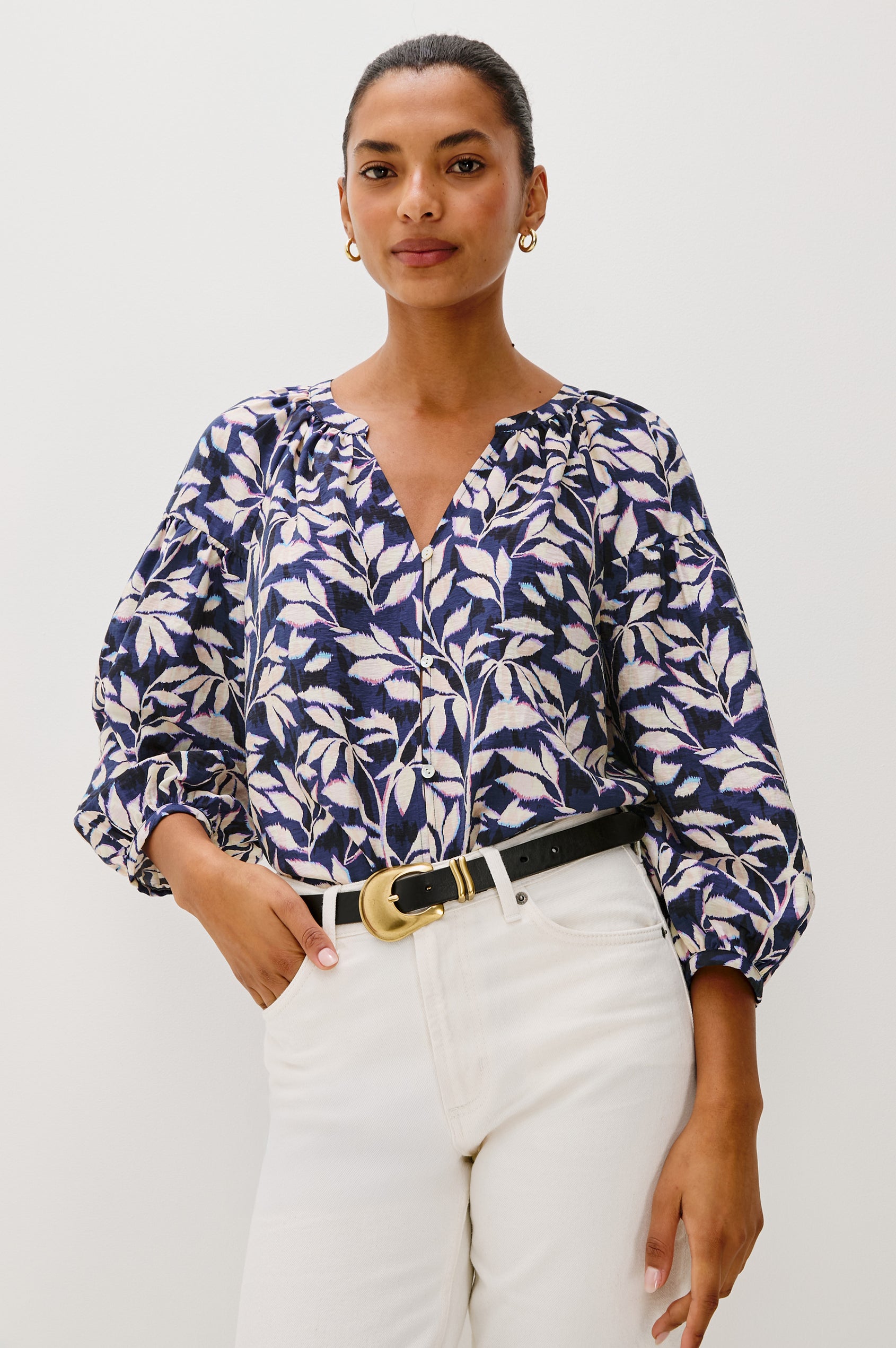 Vasia loose fitted long sleeve top with front button closure and raglan sleeves in Navy Vines print - front view featured on model, tucked in with belt