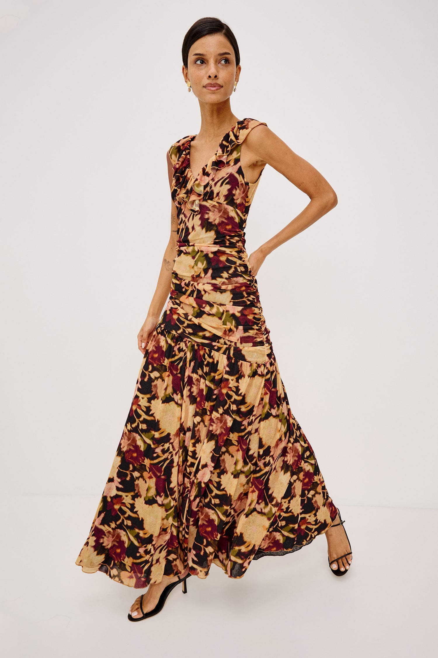 Veda Maxi Dress in Self-Lined Mesh With Sleeveless Cut, Full Lining, Ruffle V-Neckline, Ruched Bodice, and A-Line Skirt in Dark Flora Colorway - Full Body Front View Featured on Model
