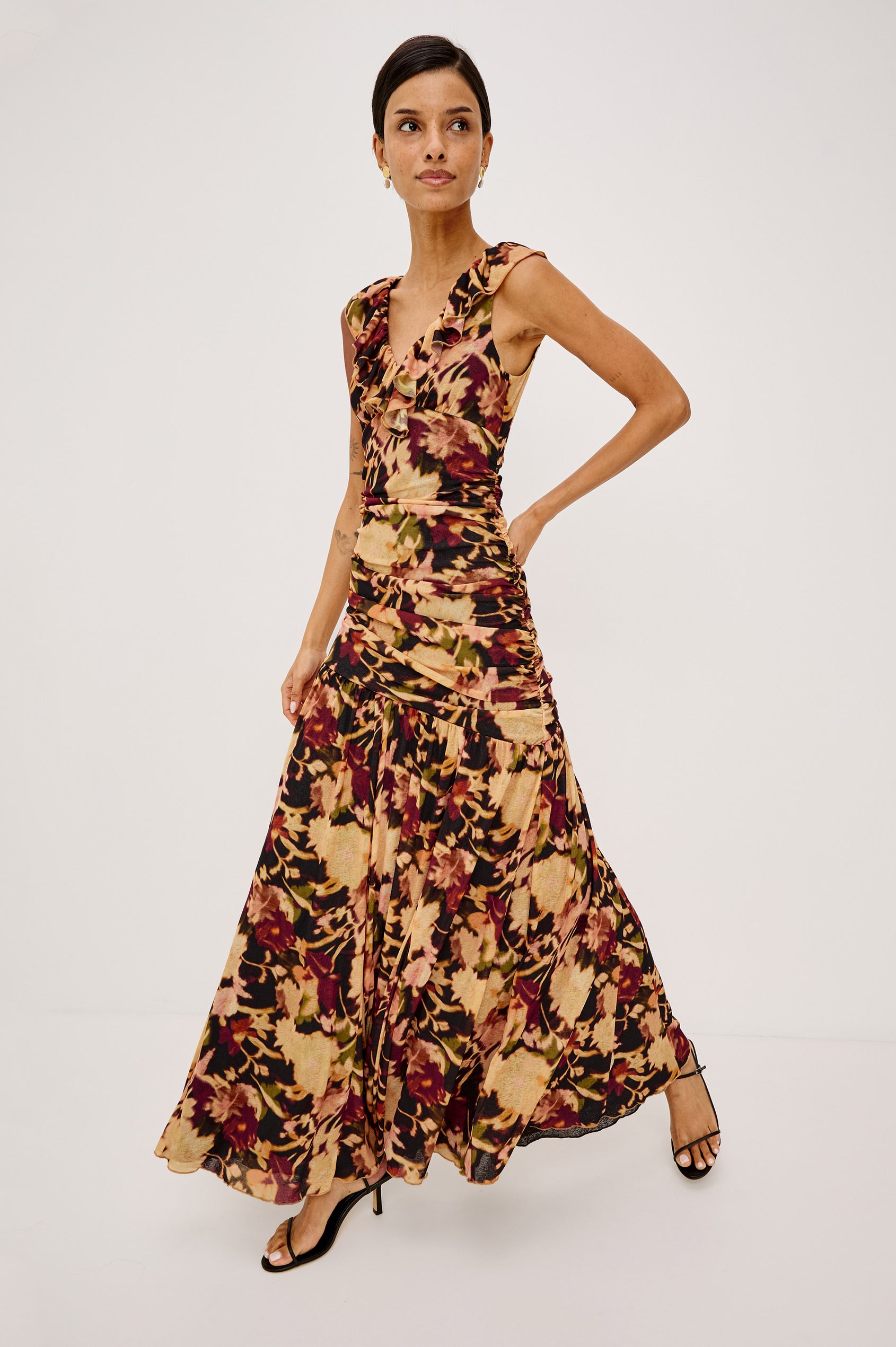 Veda Maxi Dress in Self-Lined Mesh With Sleeveless Cut, Full Lining, Ruffle V-Neckline, Ruched Bodice, and A-Line Skirt in Dark Flora Colorway - Full Body Front View Featured on Model