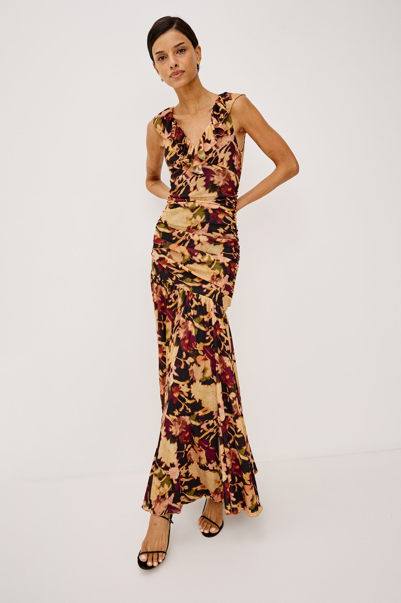 Veda Maxi Dress in Self-Lined Mesh With Sleeveless Cut, Full Lining, Ruffle V-Neckline, Ruched Bodice, and A-Line Skirt in Dark Flora Colorway - Full Body Front View Featured on Model