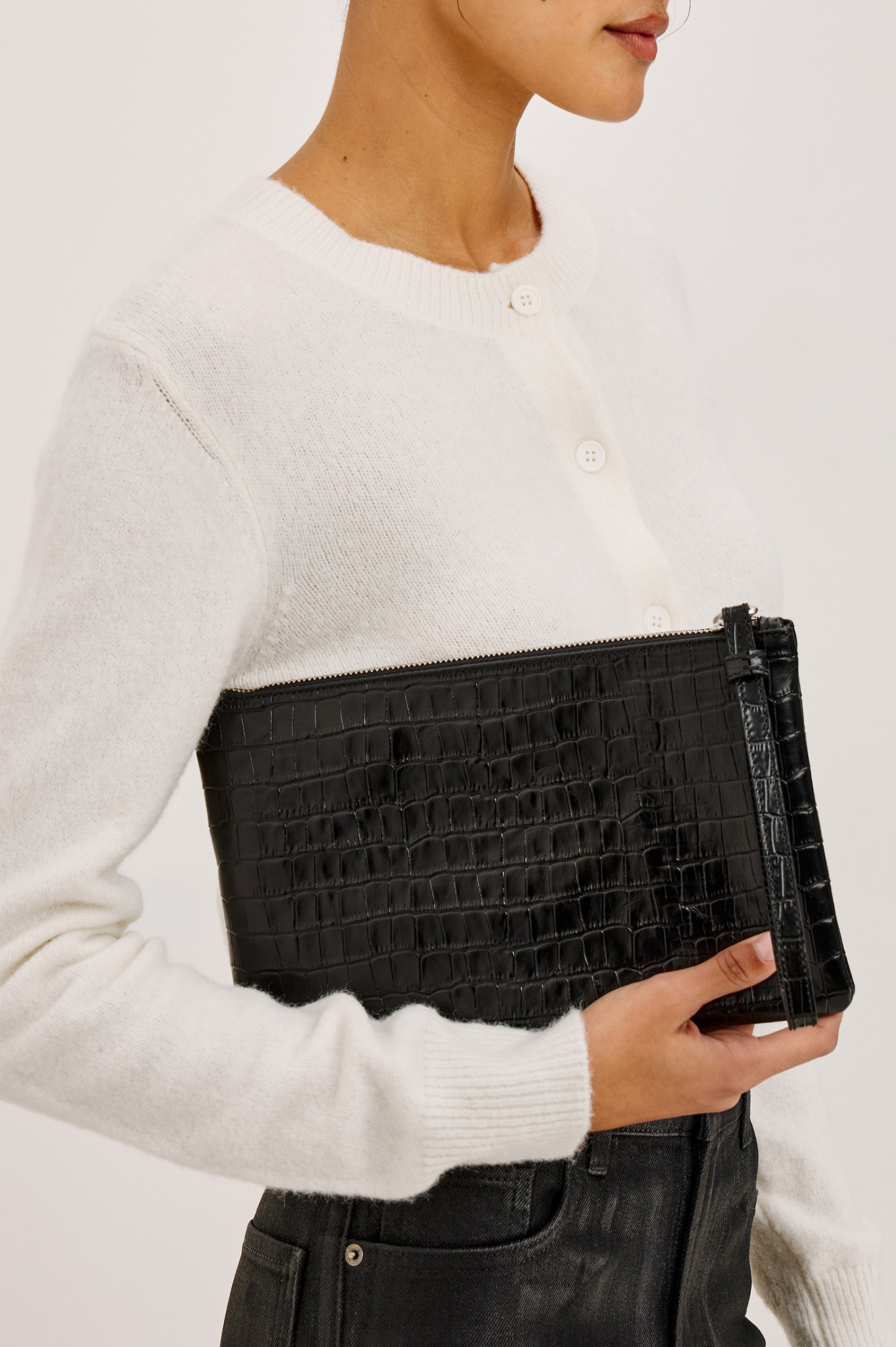 Verona Clutch Bag in Croc-Embossed Leather With Attached Wristlet Strap, Top Zip Closure, and Interior Slip Pocket in Black Croc Embossed Colorway - Back View Featured on Model.