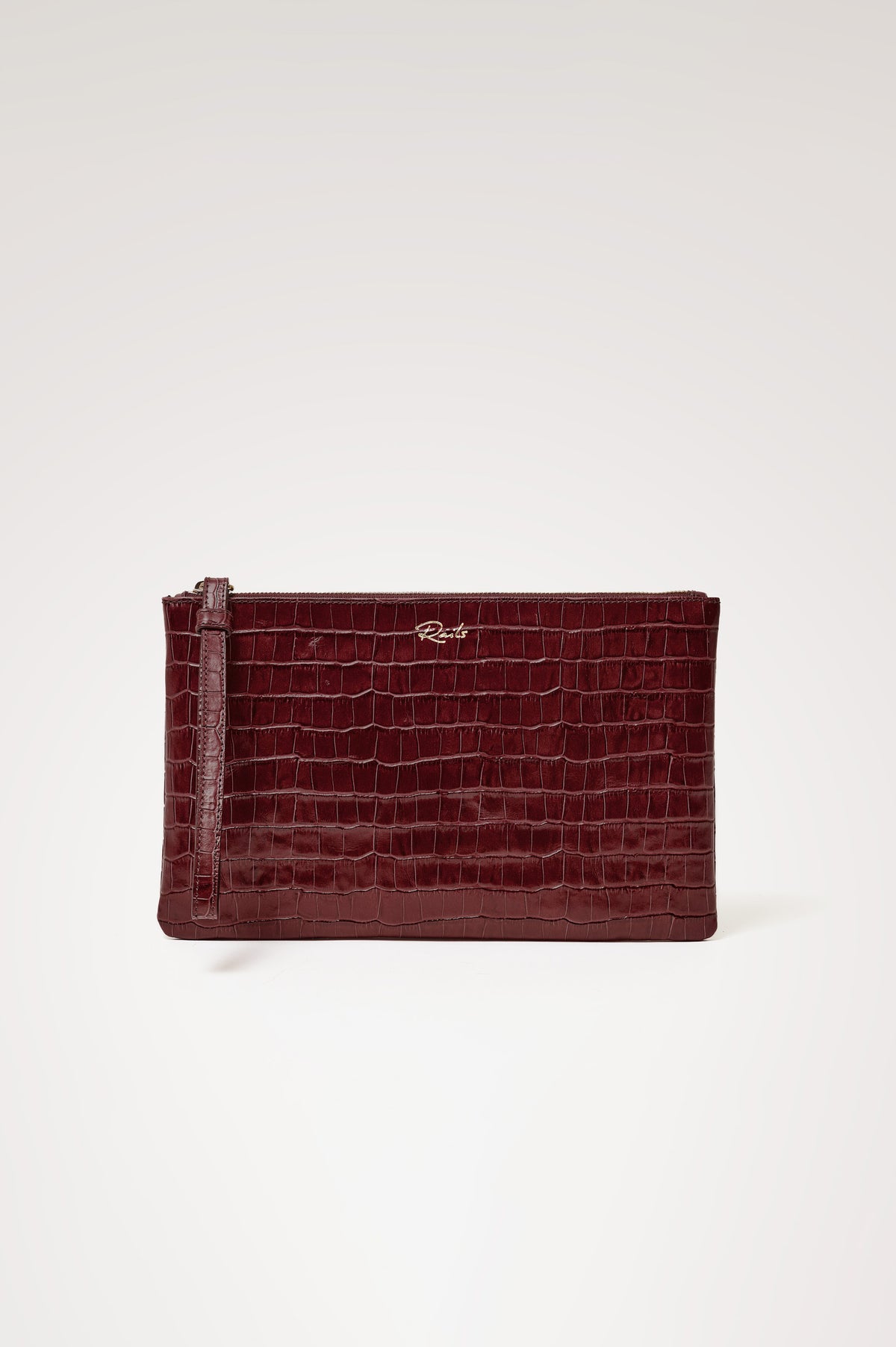 Verona Clutch Bag in Croc-Embossed Leather With Attached Wristlet Strap, Top Zip Closure, and Interior Slip Pocket in Burgundy Croc Embossed Colorway - Side View Featured on Model