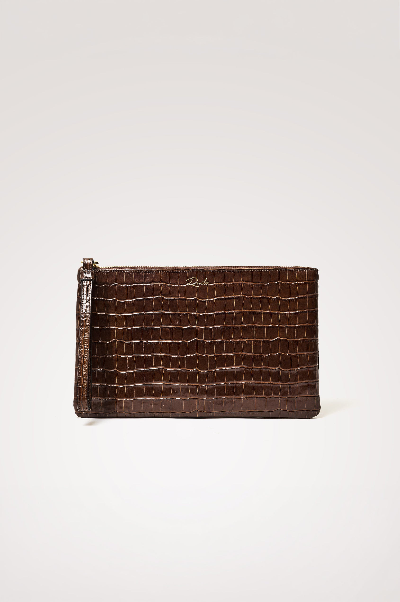 Verona Clutch Bag in Croc-Embossed Leather With Attached Wristlet Strap, Top Zip Closure, and Interior Slip Pocket in Brown Croc Embossed Colorway - Mid Body Side View Featured on Model