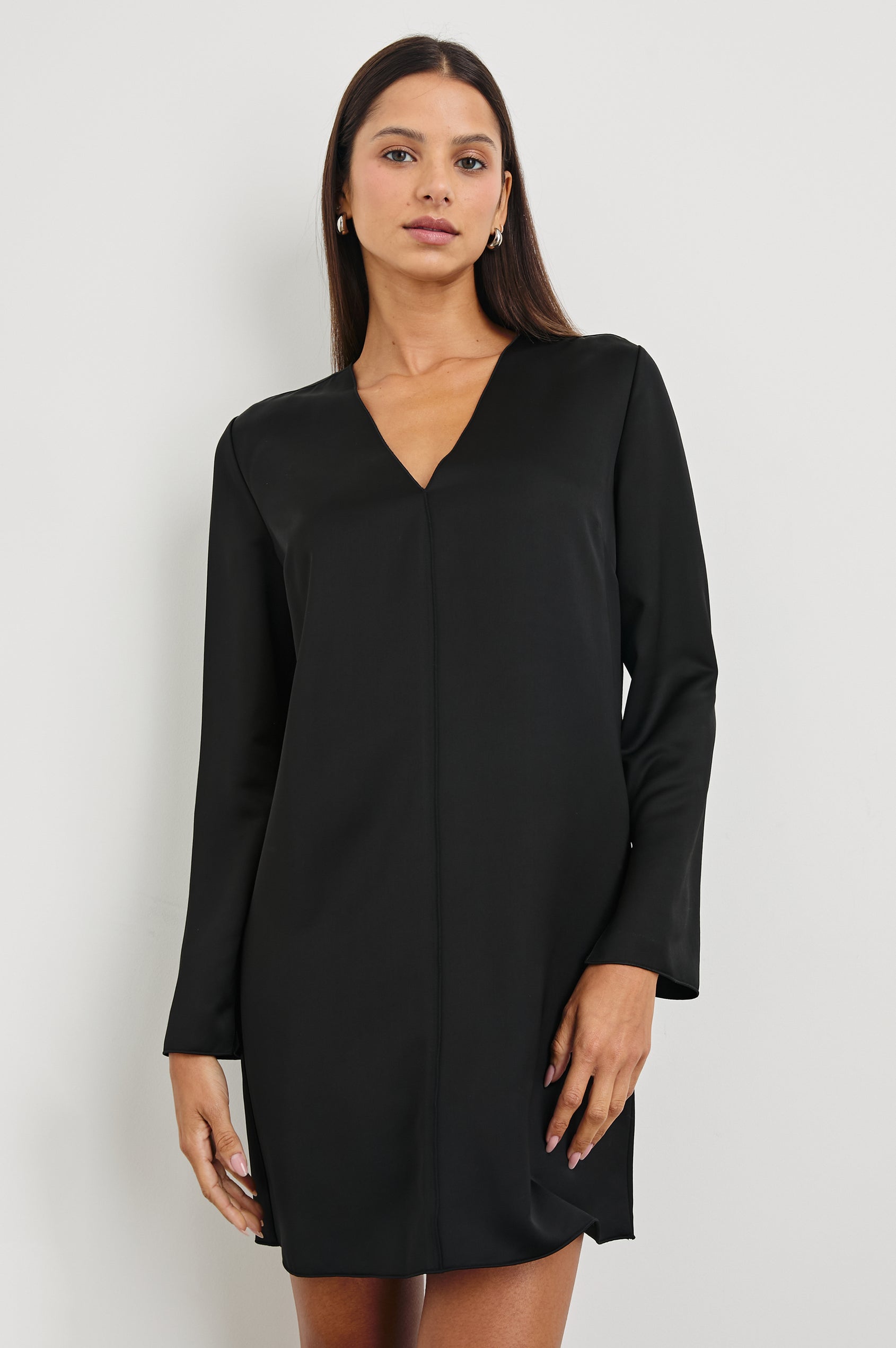 Victoria Long-Sleeve Mini Dress with a V Neck, and Front and Back Center Vertical Seams in Black Colorway - Front View Featured on Model 