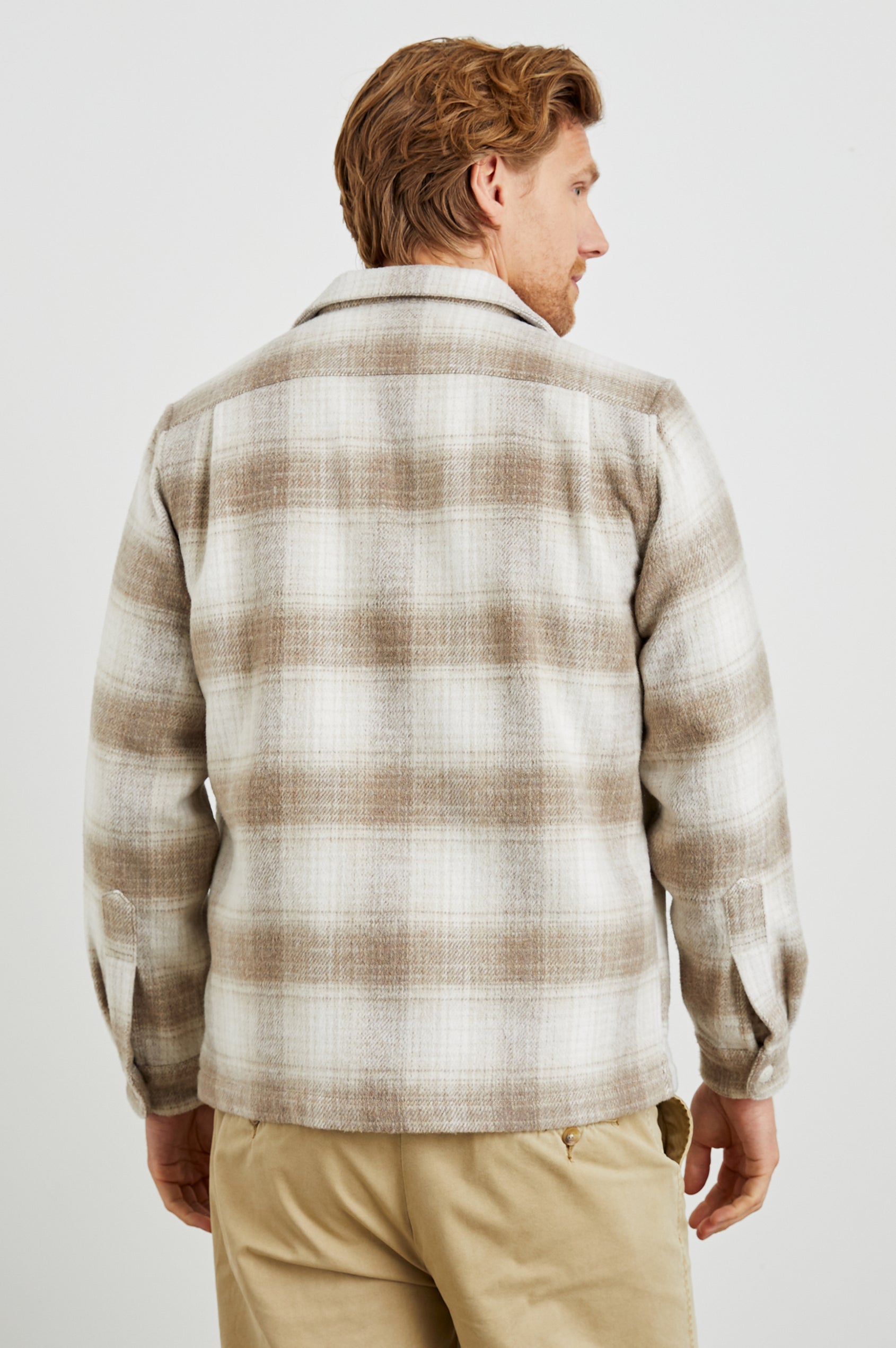 Viggo Long-Sleeve Shirt Jacket with Button Closure and Two Button Chest Flap Pockets in Lions Mane Colorway, a Tan and White Plaid - Back Unbuttoned View Featured on Model