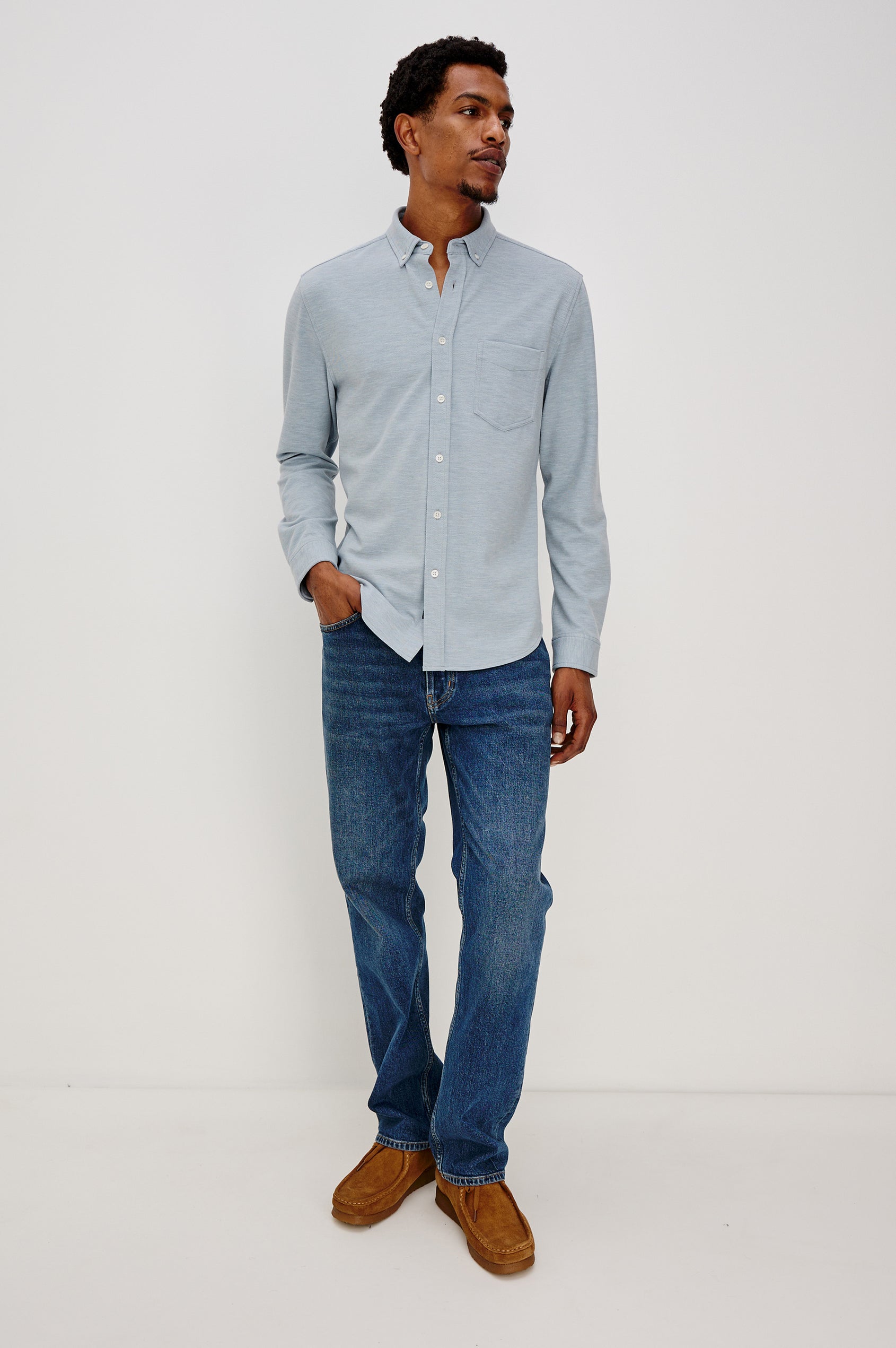Vincent is a collared long sleeve button front shirt with a chest pocket in Blue Oxford colorway. Front view featured on model.