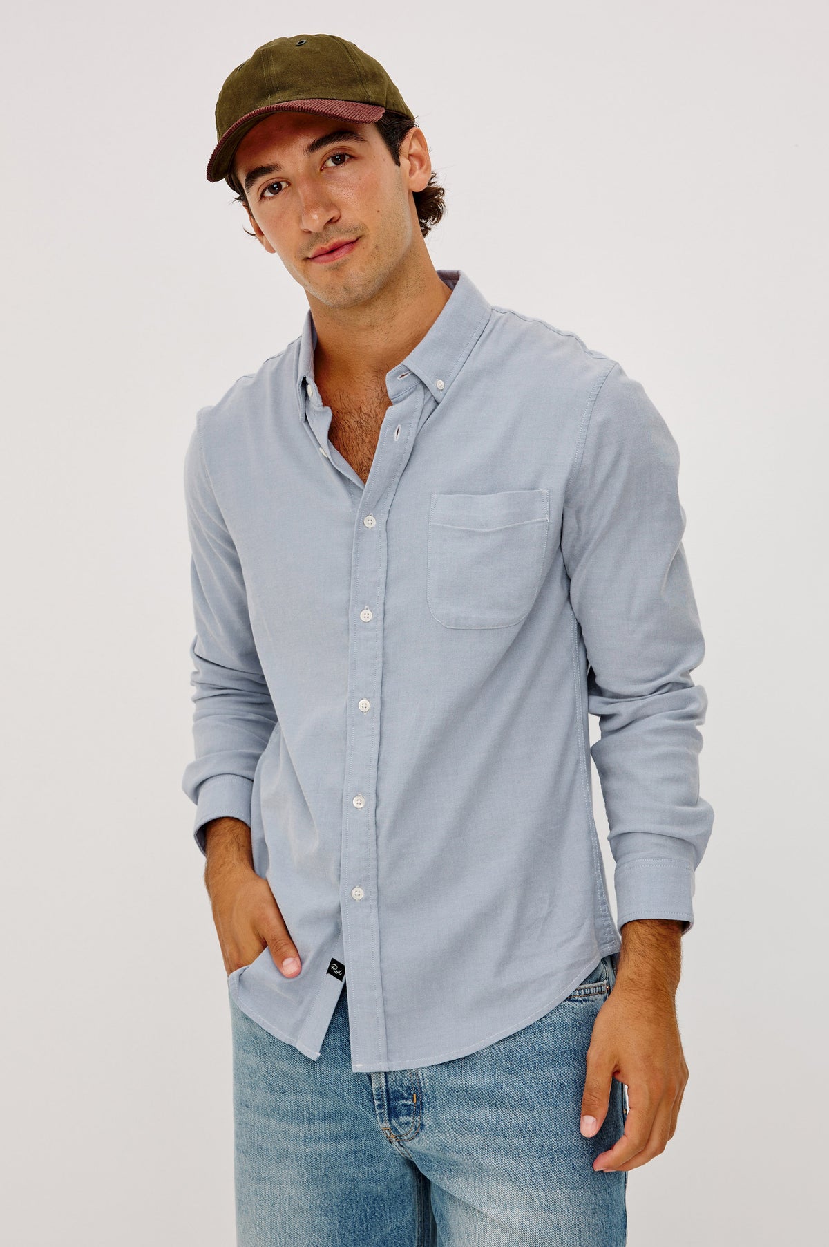 Vincent is a Collared Long Sleeve Button Front Shirt with a Chest Pocket in Blue Oxford Colorway - Upper Body Front View Featured on Model.
