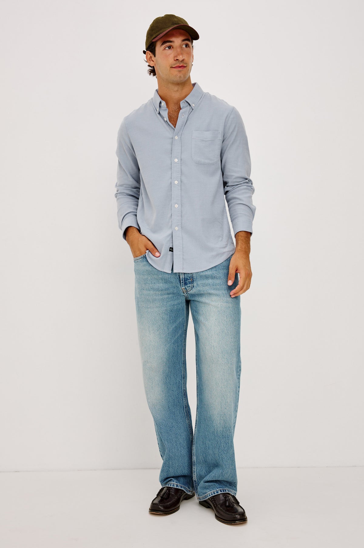 Vincent is a Collared Long Sleeve Button Front Shirt with a Chest Pocket in Blue Oxford Colorway - Full Body Front View Featured on Model.
