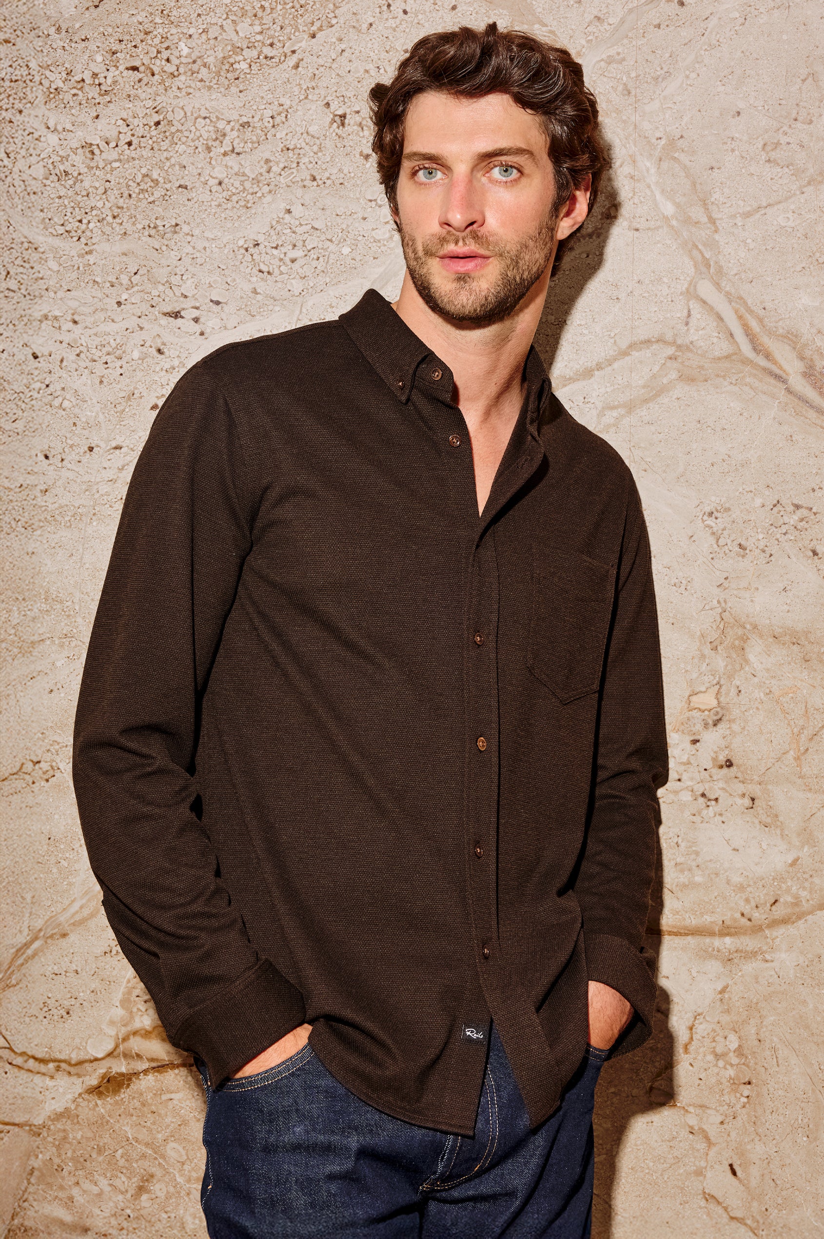 Vincent is a collared long sleeve button front shirt with a chest pocket in Espresso colorway. Front view featured on model.