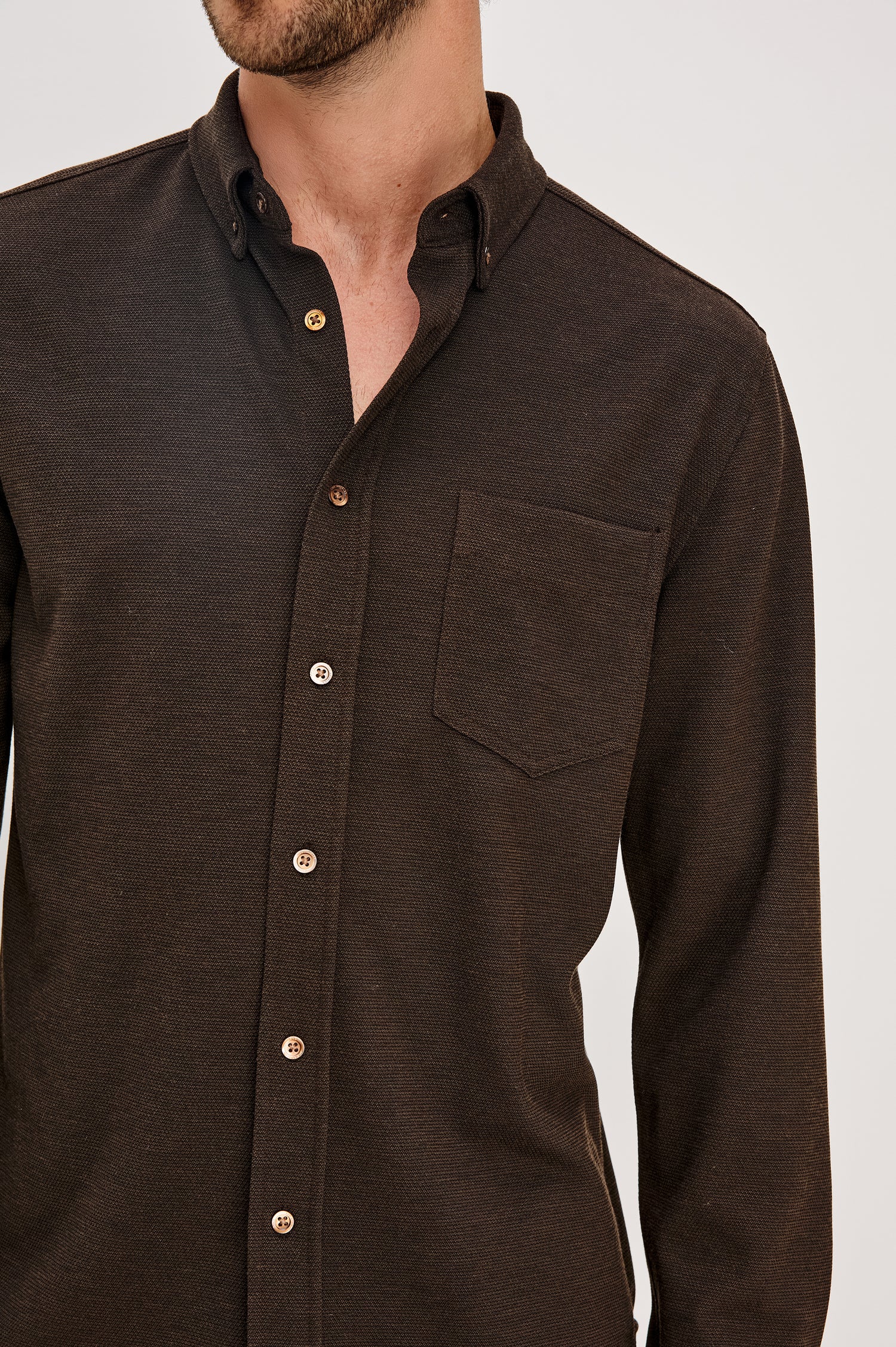Vincent is a collared long sleeve button front shirt with a chest pocket in Espresso colorway. Front detail view featured on model.