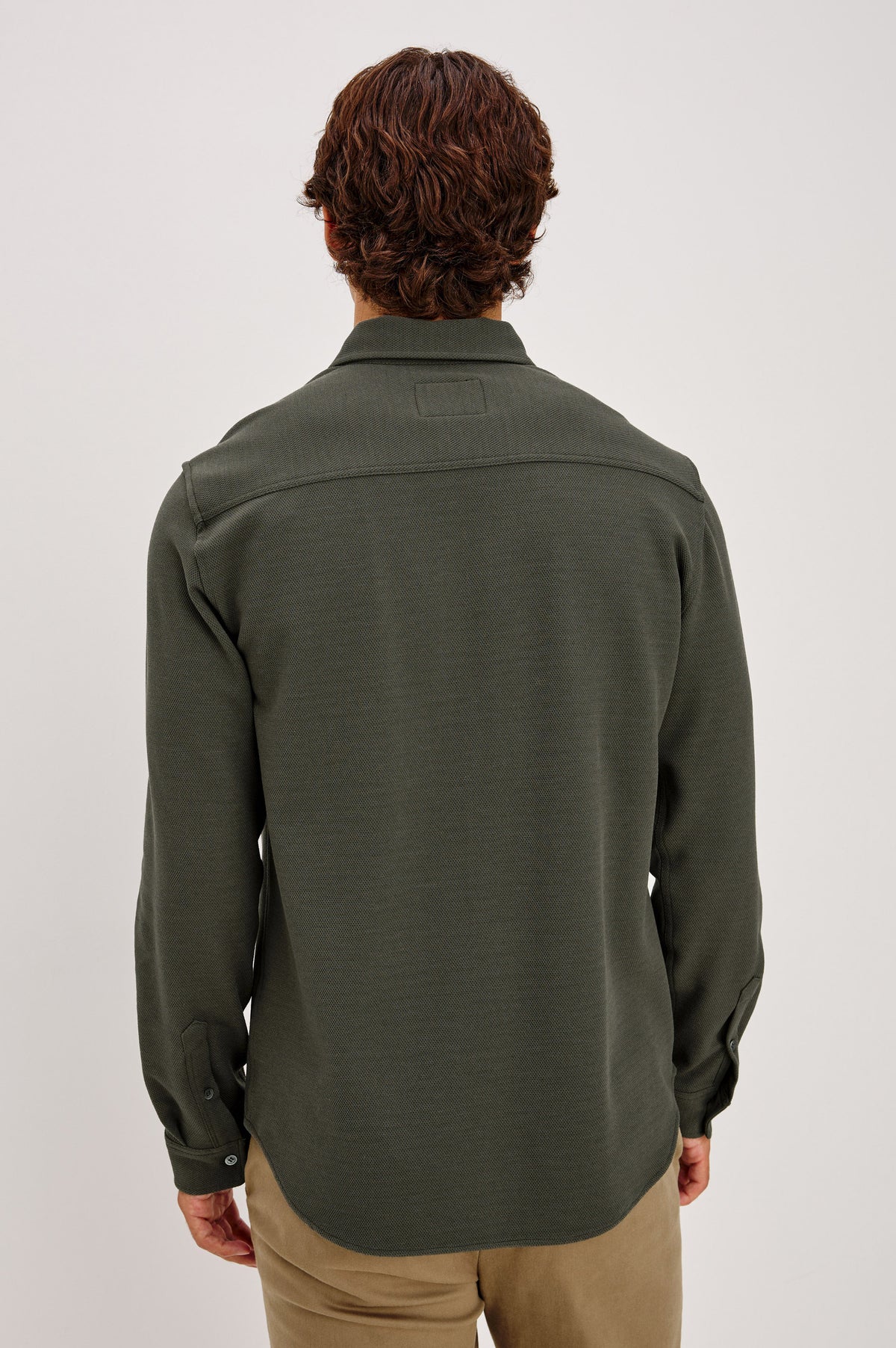 Vincent is a Collared Long Sleeve Button Front Shirt with a Chest Pocket in Hunter Green Colorway - Upper Body Back View Featured on Model.