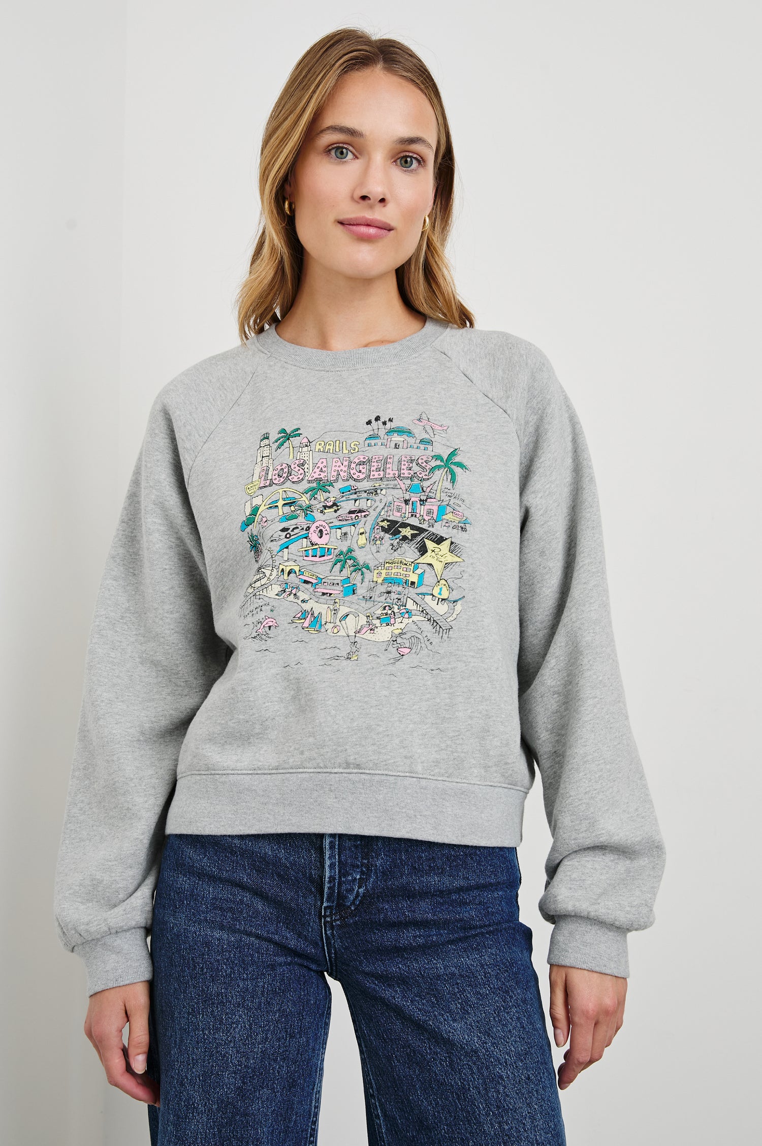 Vintage Raglan Long-Sleeve Sweatshirt with a Crew Neck, an image of landmarks in Los Angeles and the Text, Rails Los Angeles in Rails Los Angeles Map Grey Colorway, Mostly Pink, Yellow and Blue on Grey - Front View Featured on Model