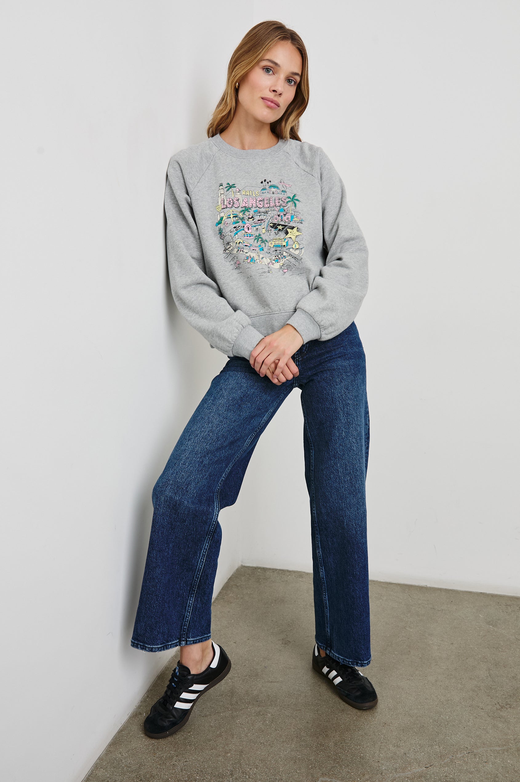 Vintage Raglan Long-Sleeve Sweatshirt with a Crew Neck, an image of landmarks in Los Angeles and the Text, Rails Los Angeles in Rails Los Angeles Map Grey Colorway, Mostly Pink, Yellow and Blue on Grey - Front Full Body View Featured on Model