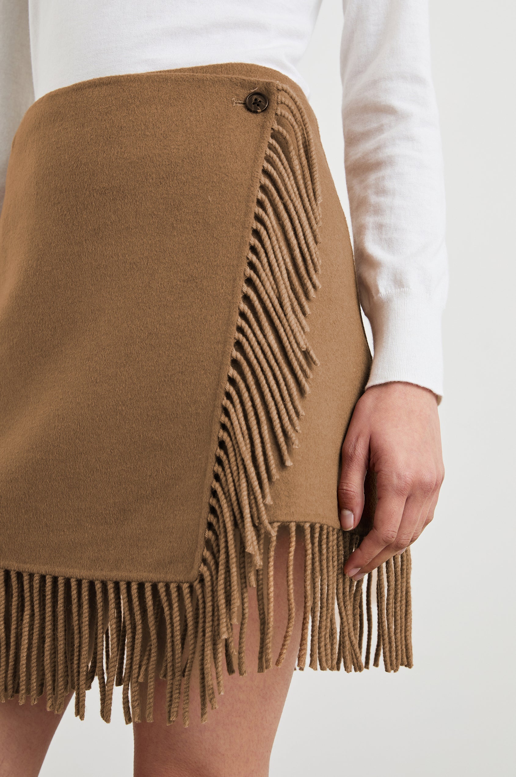 Vista Mini Wrap Skirt with a Button Closure and Fringe along the Hem in Camel Colorway - Front View Featured on Model