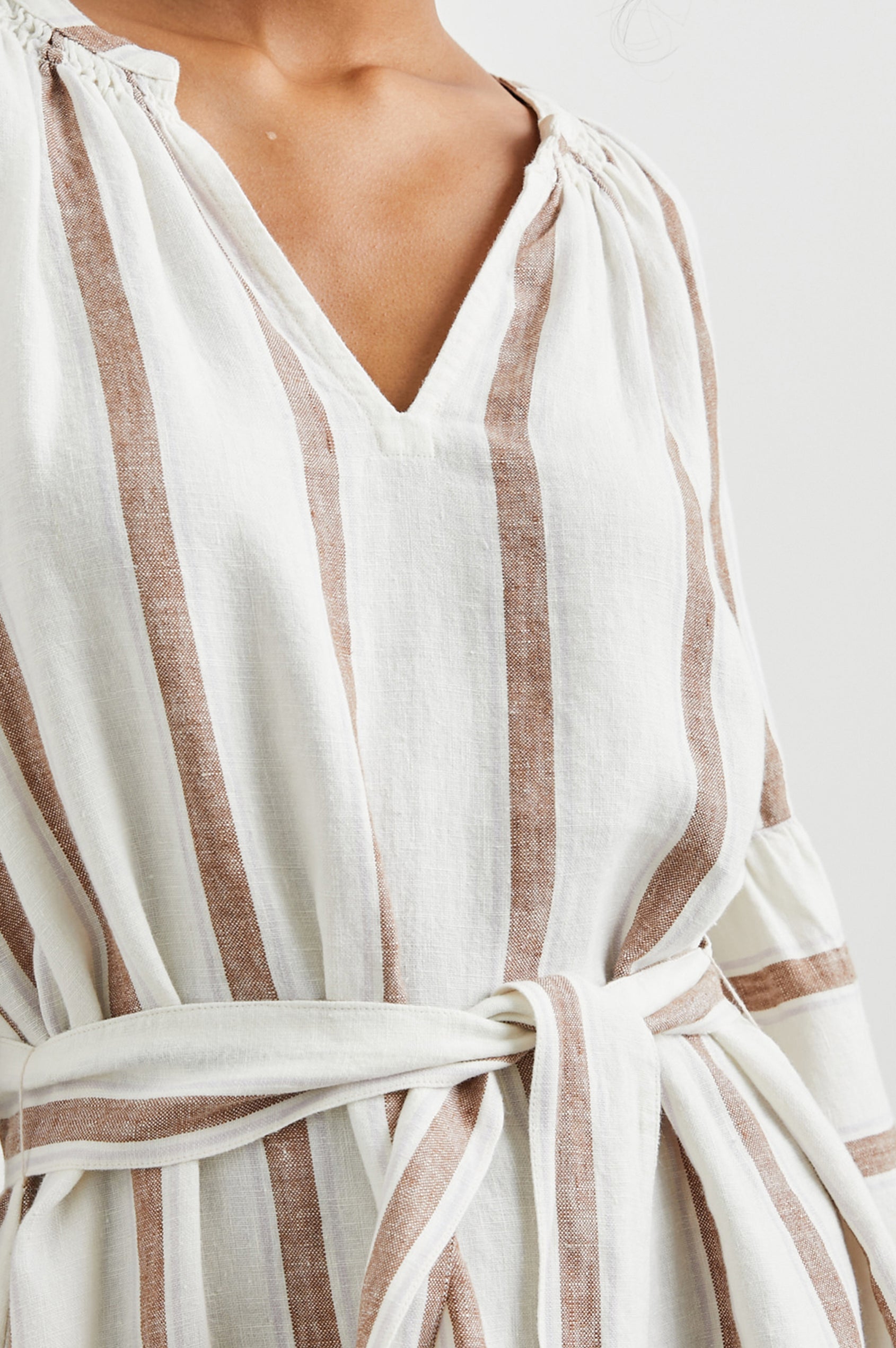 Vittoria Midi Dress with Three-Quarter Sleeves, a V Neck, Light Ruching at the Collar, and a Fabric Tie Belt in Coconut Stripe Colorway, Coconut Vertical Stripes on White with Horizontal Stripes at the Hem - Front View Featured on Model