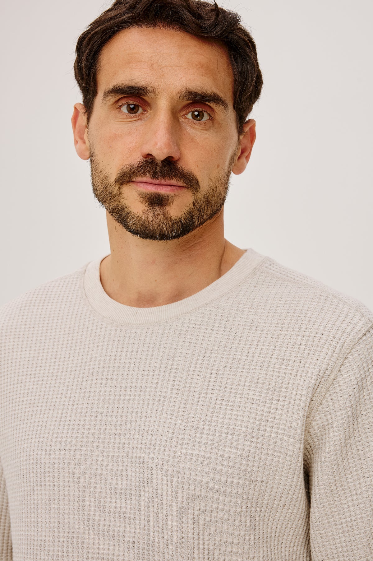 Wade Long-Sleeve Waffle Knit Thermal with a Crew Neck in Oat Heather Colorway - Upper Body Front Detail View Featured on Model.