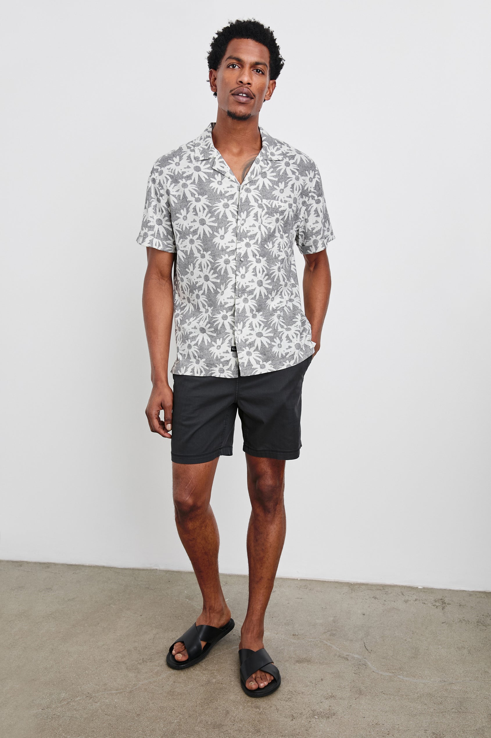 Waimea short sleeve button down shirt with camp collar and floral pattern details in Perennial Charcoal White - full body front view on model
