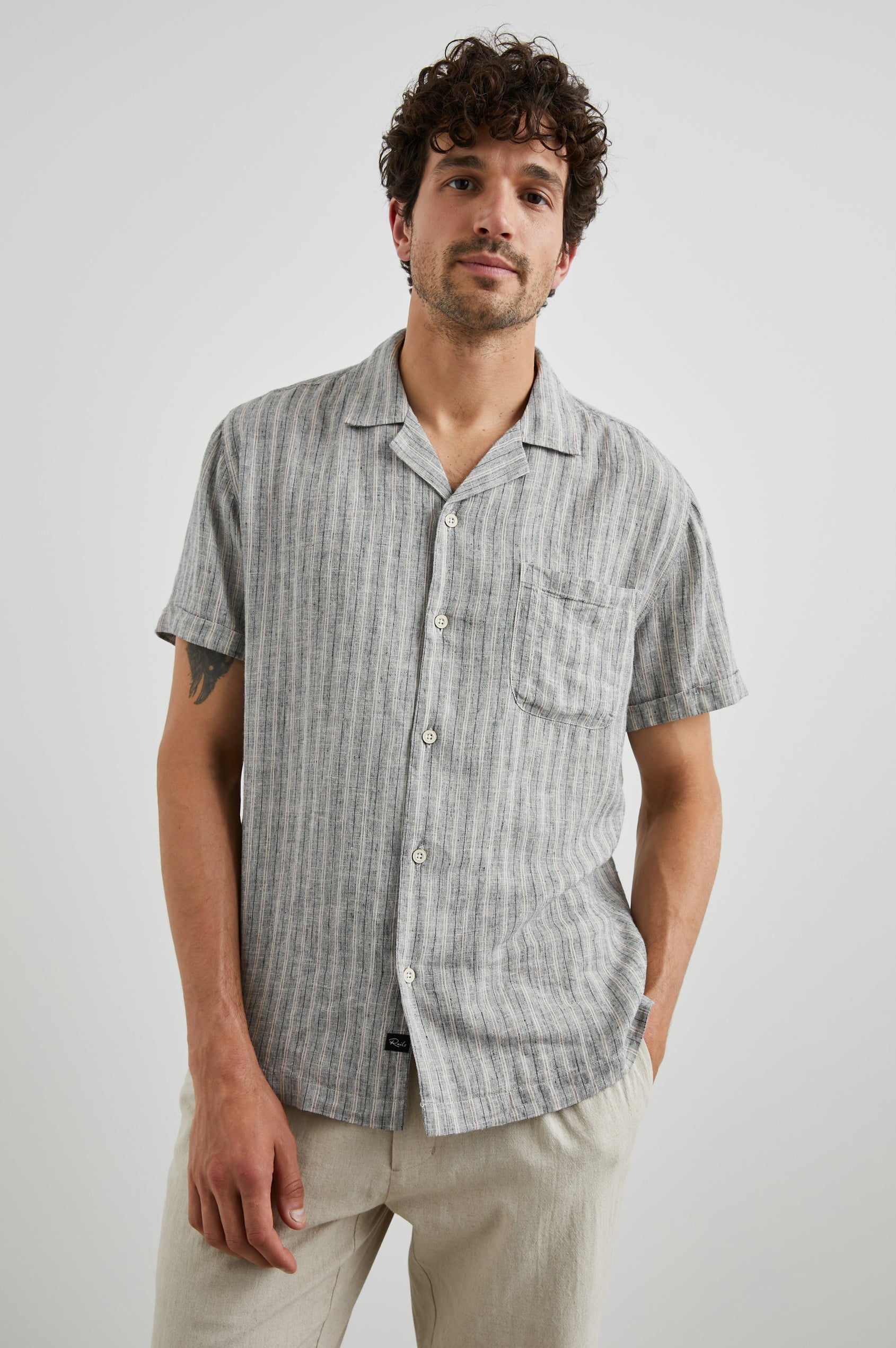 Waimea Short-Sleeve Button Up with a Chest Patch Pocket in Quinoa Navy Stripe Colorway, Thin Vertical White and Navy Stripes on Quinoa - Front View Featured on Model