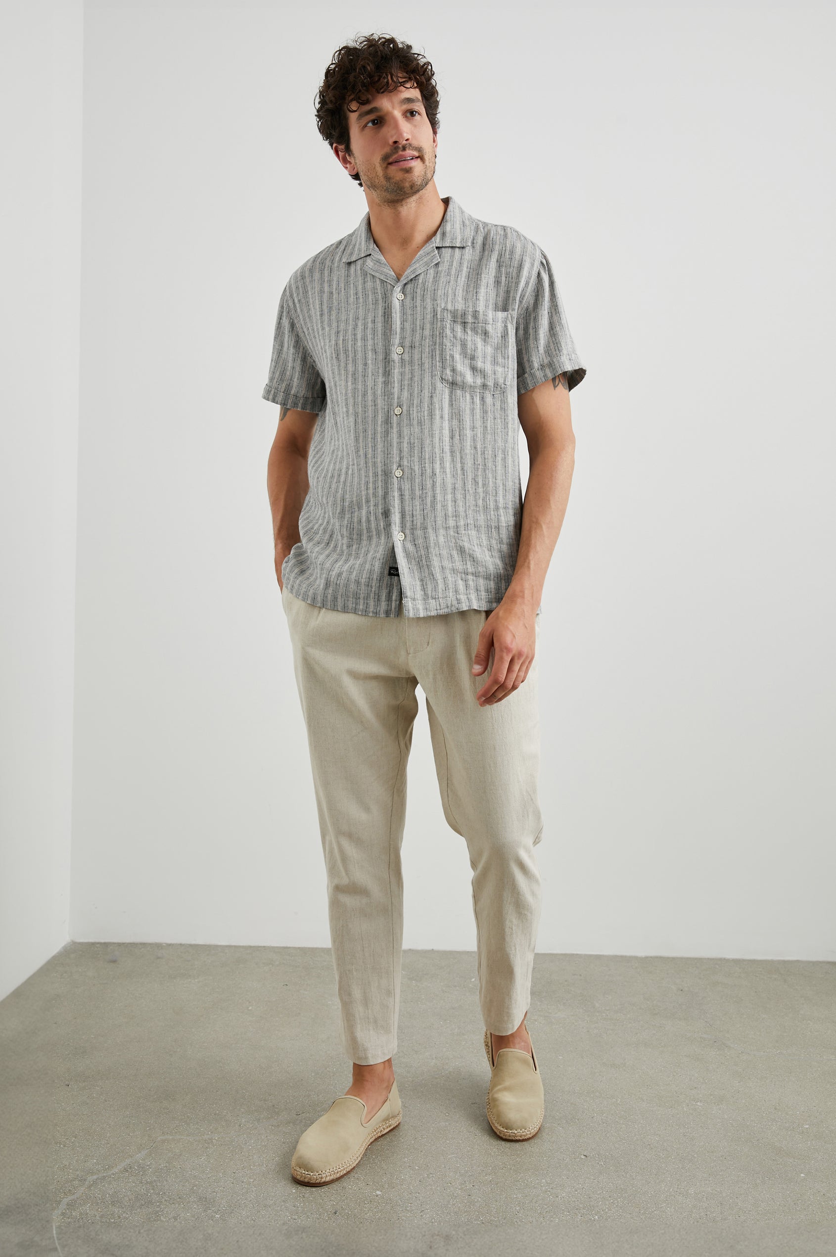 Waimea Short-Sleeve Button Up with a Chest Patch Pocket in Quinoa Navy Stripe Colorway, Thin Vertical White and Navy Stripes on Quinoa - Front Full Body View Featured on Model