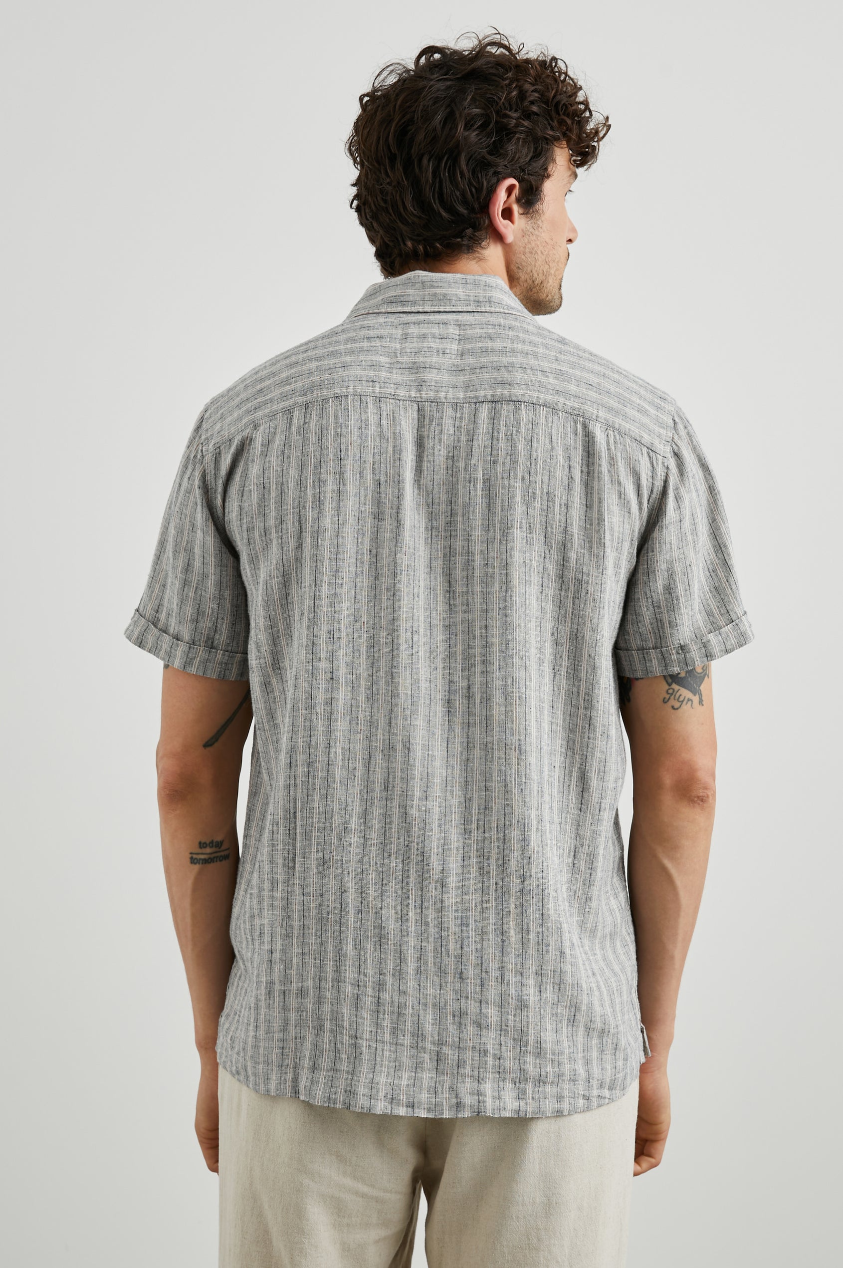 Waimea Short-Sleeve Button Up with a Chest Patch Pocket in Quinoa Navy Stripe Colorway, Thin Vertical White and Navy Stripes on Quinoa - Back View Featured on Model
