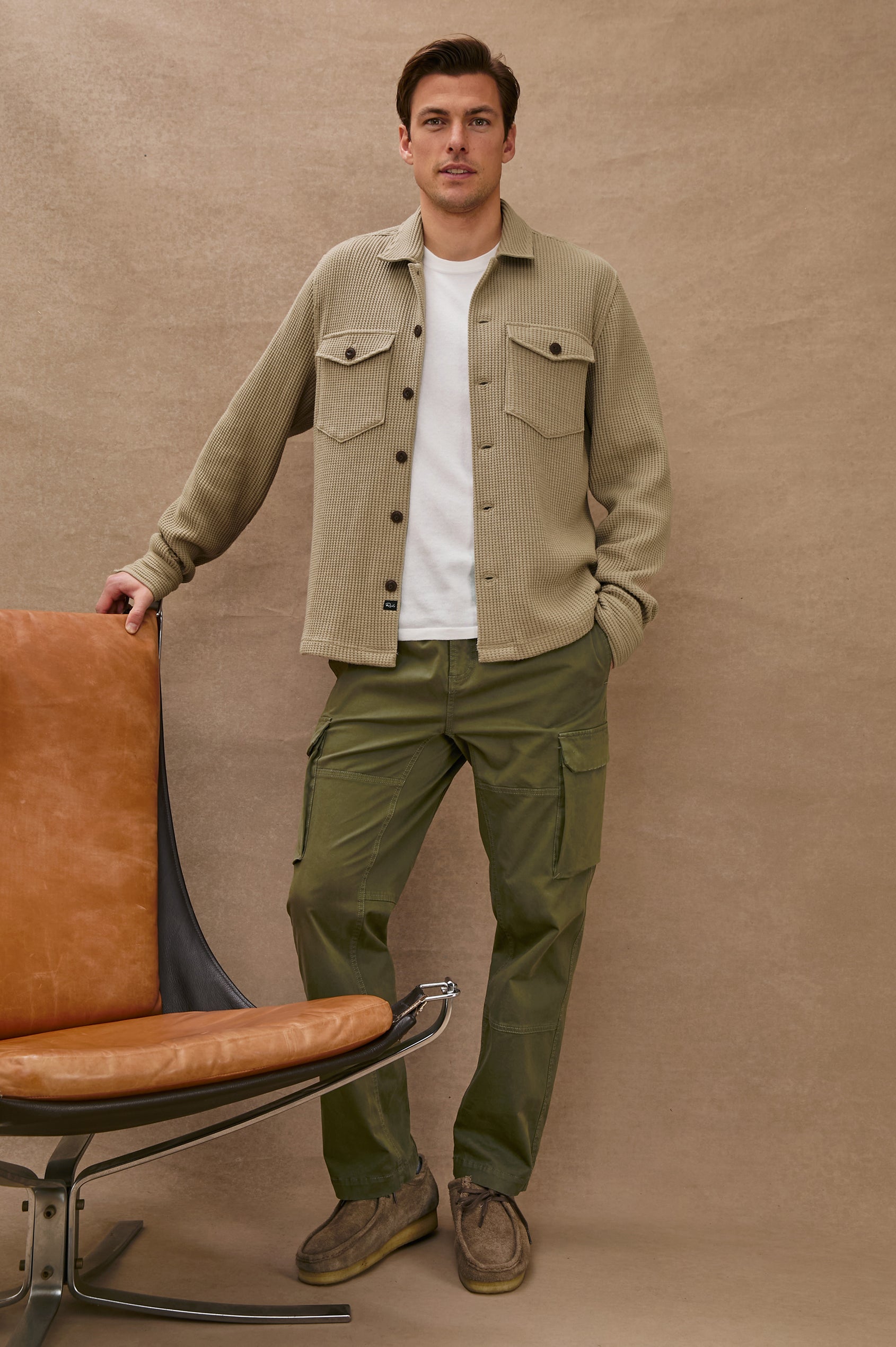 The Wells is a collared button front shirt jacket with contrast brown buttons and two chest pockets in Barley colorway. Front full body view featured on model.