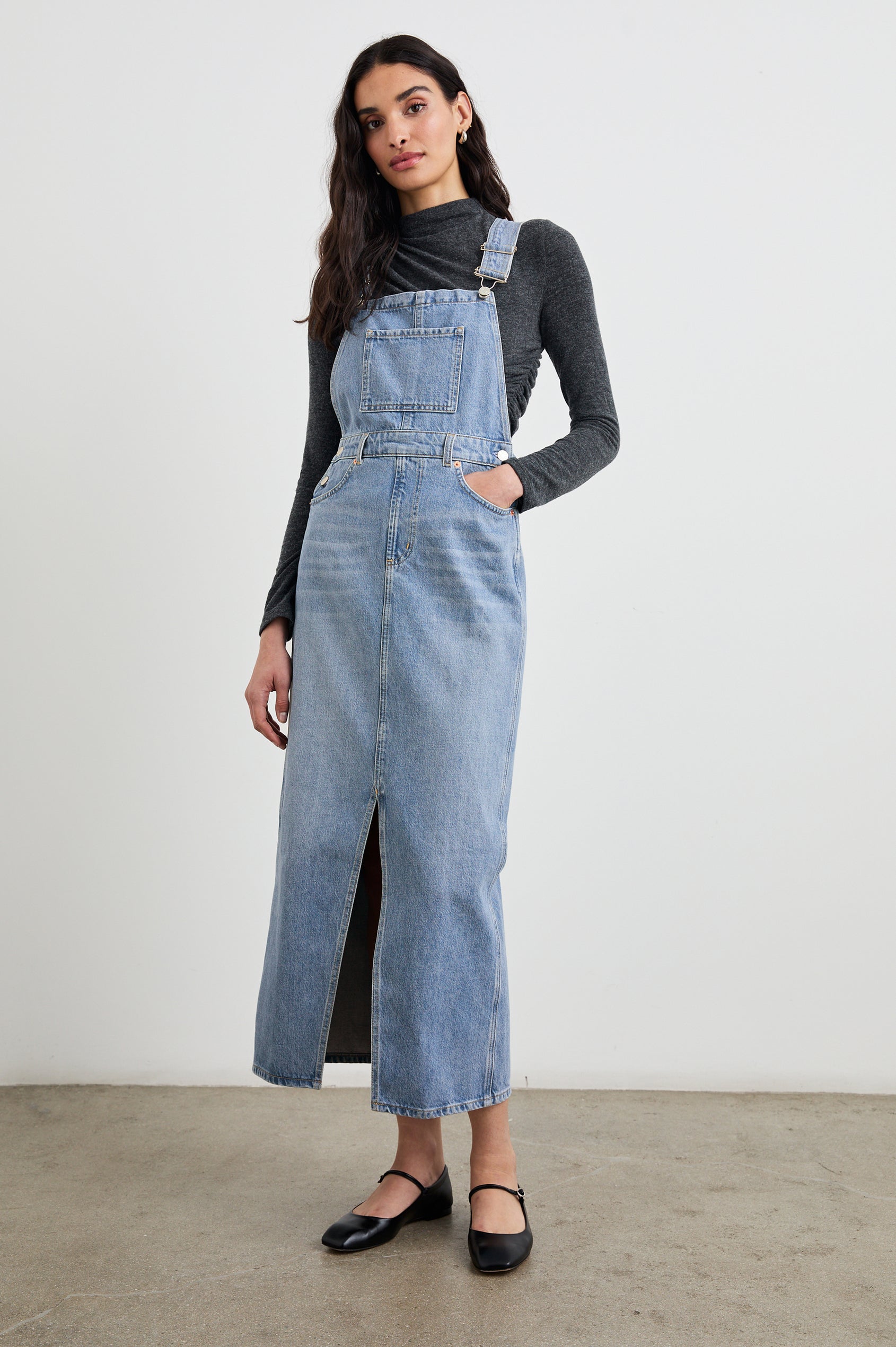 Westlake Midi Denim Dress with an Overalls-Style Bodice, Two Front Pockets, a Bib Chest Patch Pocket, Two Back Patch Pockets, Belt Loops and a Center Slit in South Coast Colorway - Front Full Body View Featured on Model